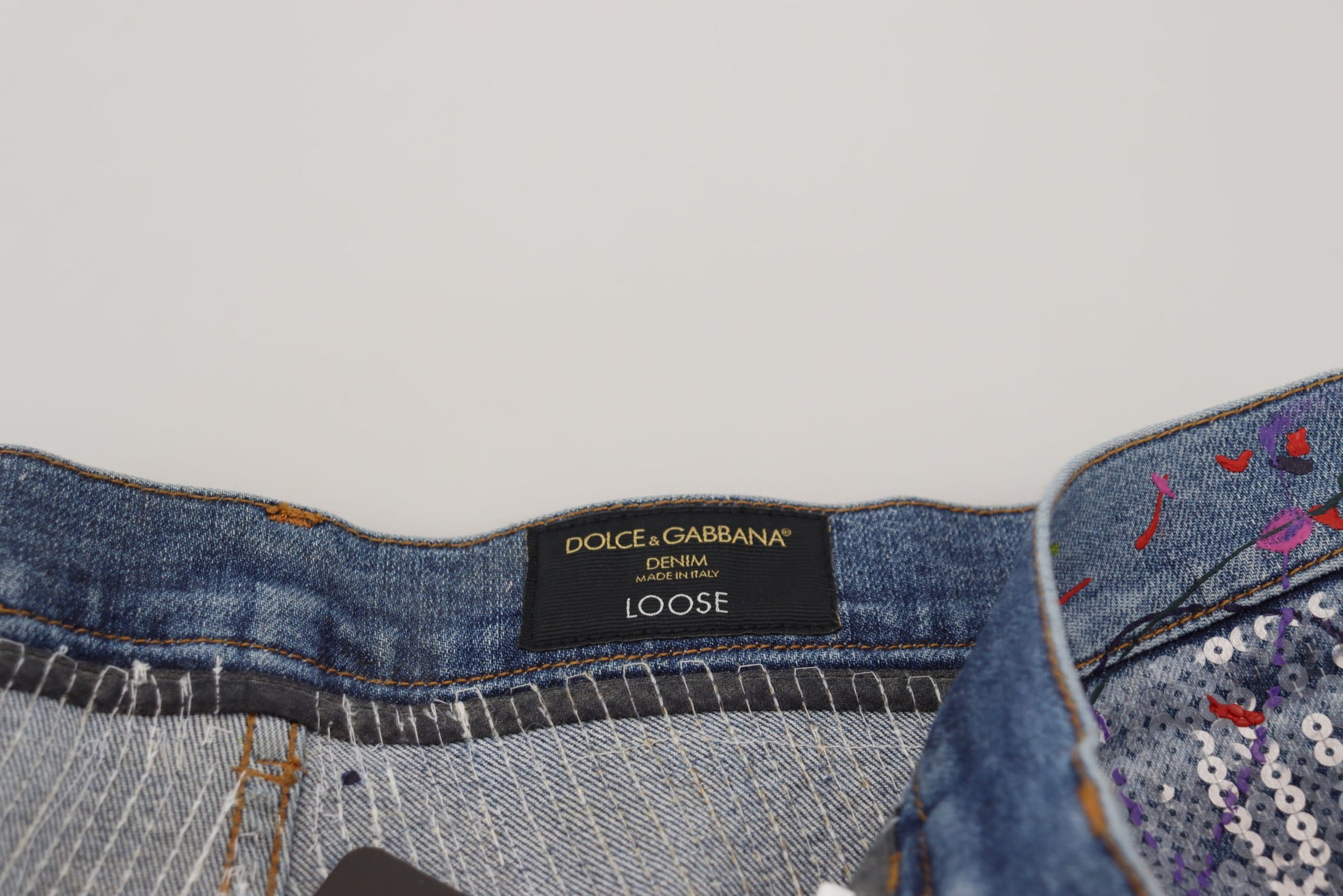 Blue denim jeans with a brand label on waistband