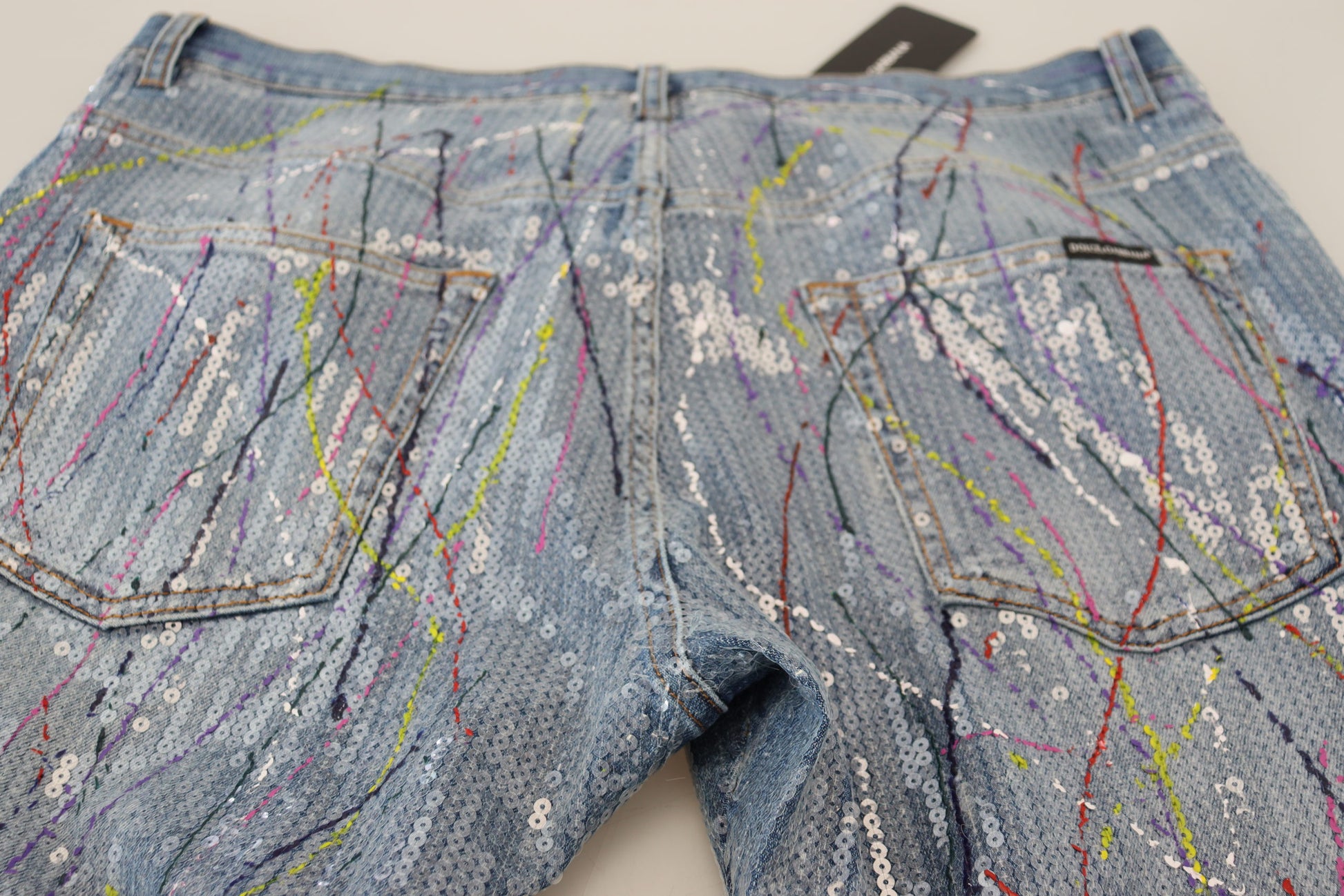 Pair of denim shorts with colorful paint splatter design