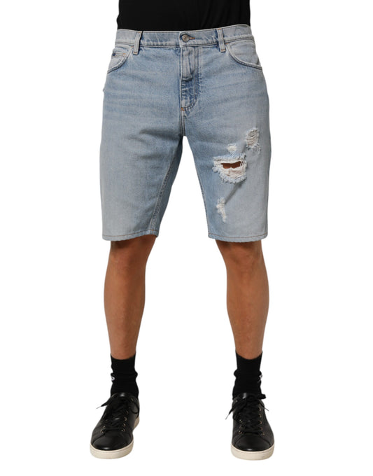 Man wearing denim shorts with holes in knees
