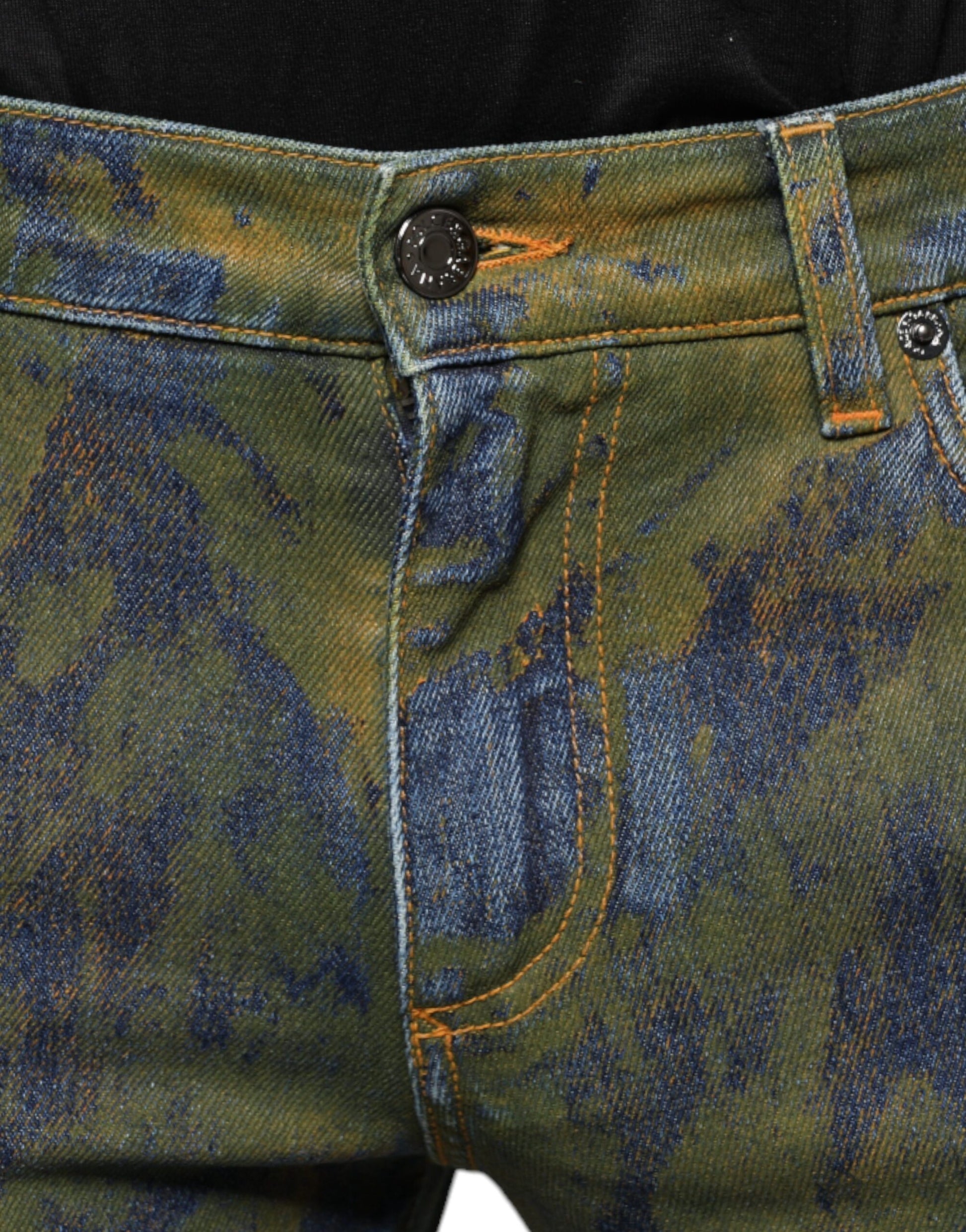 Faded blue jeans with yellow stitching on waistband