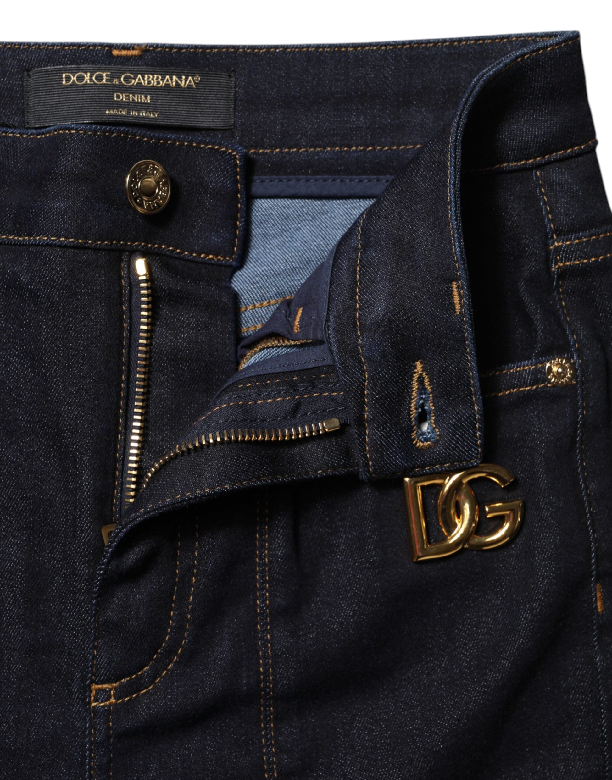 Blue denim jeans with zippered pockets and a gold logo on the right leg