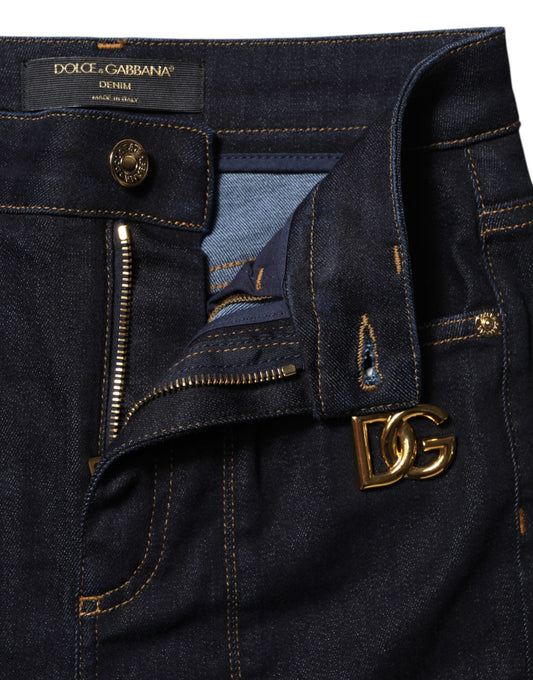 Blue denim jeans with zippered pockets and a gold logo on the right leg