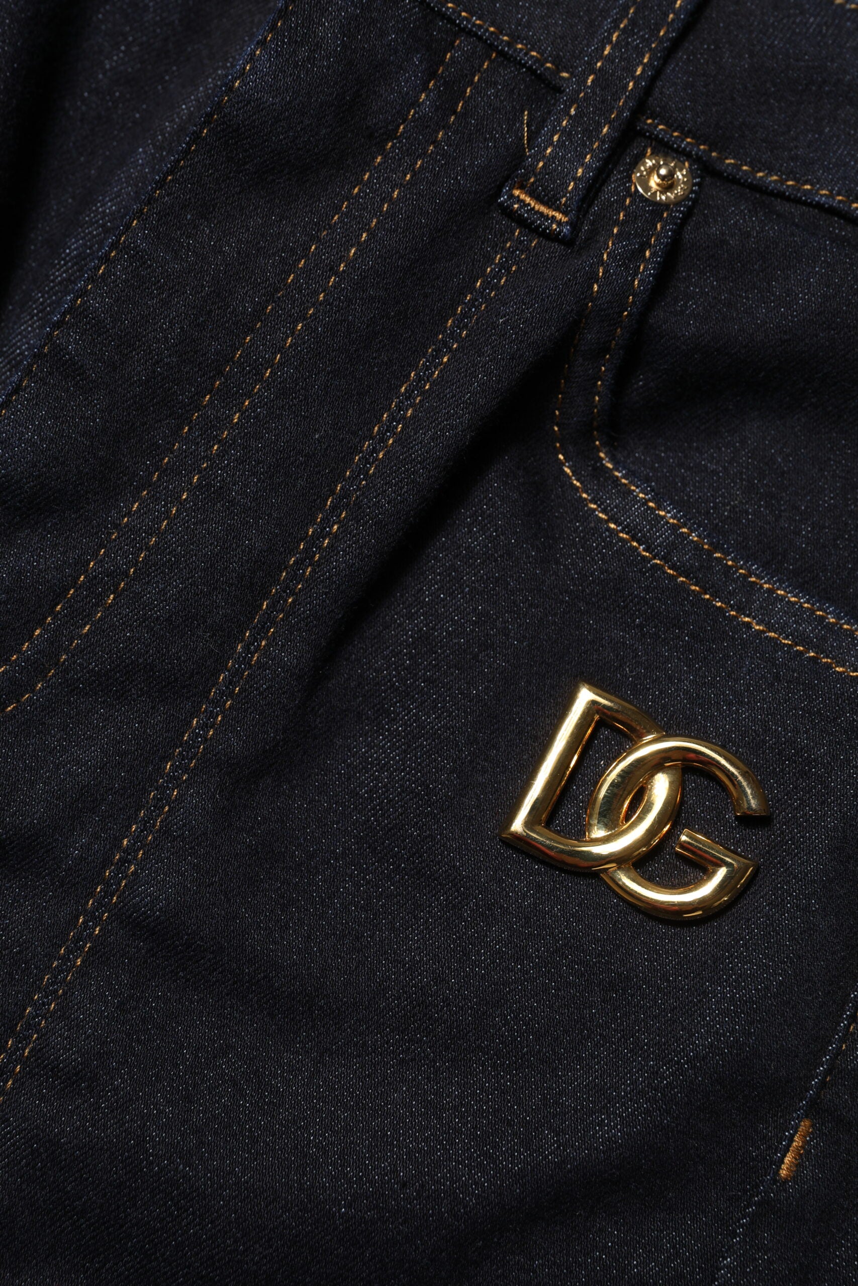 Blue jeans with gold logo on back pocket