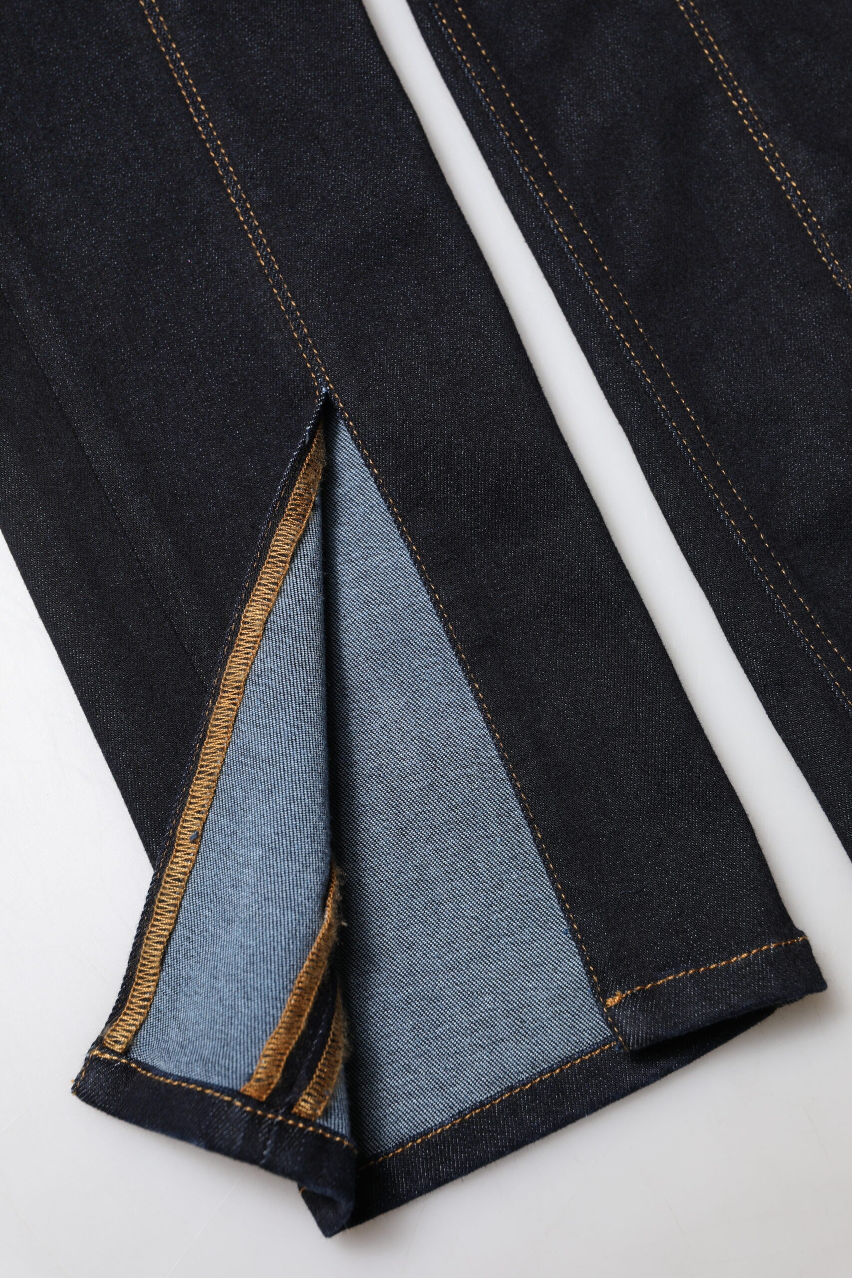 Blue denim jeans with yellow stitching on legs