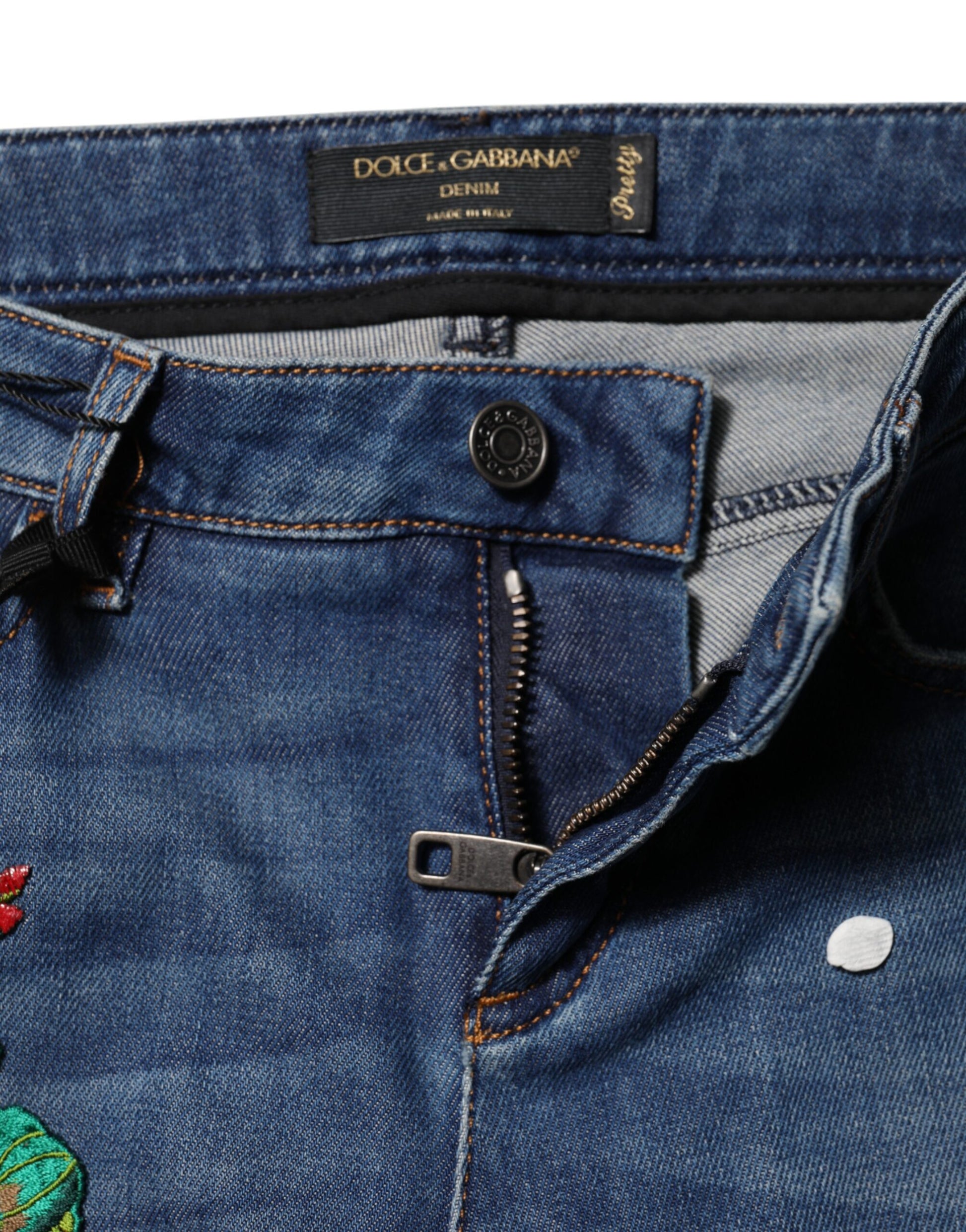 Blue denim jeans with zipper fly and button closure