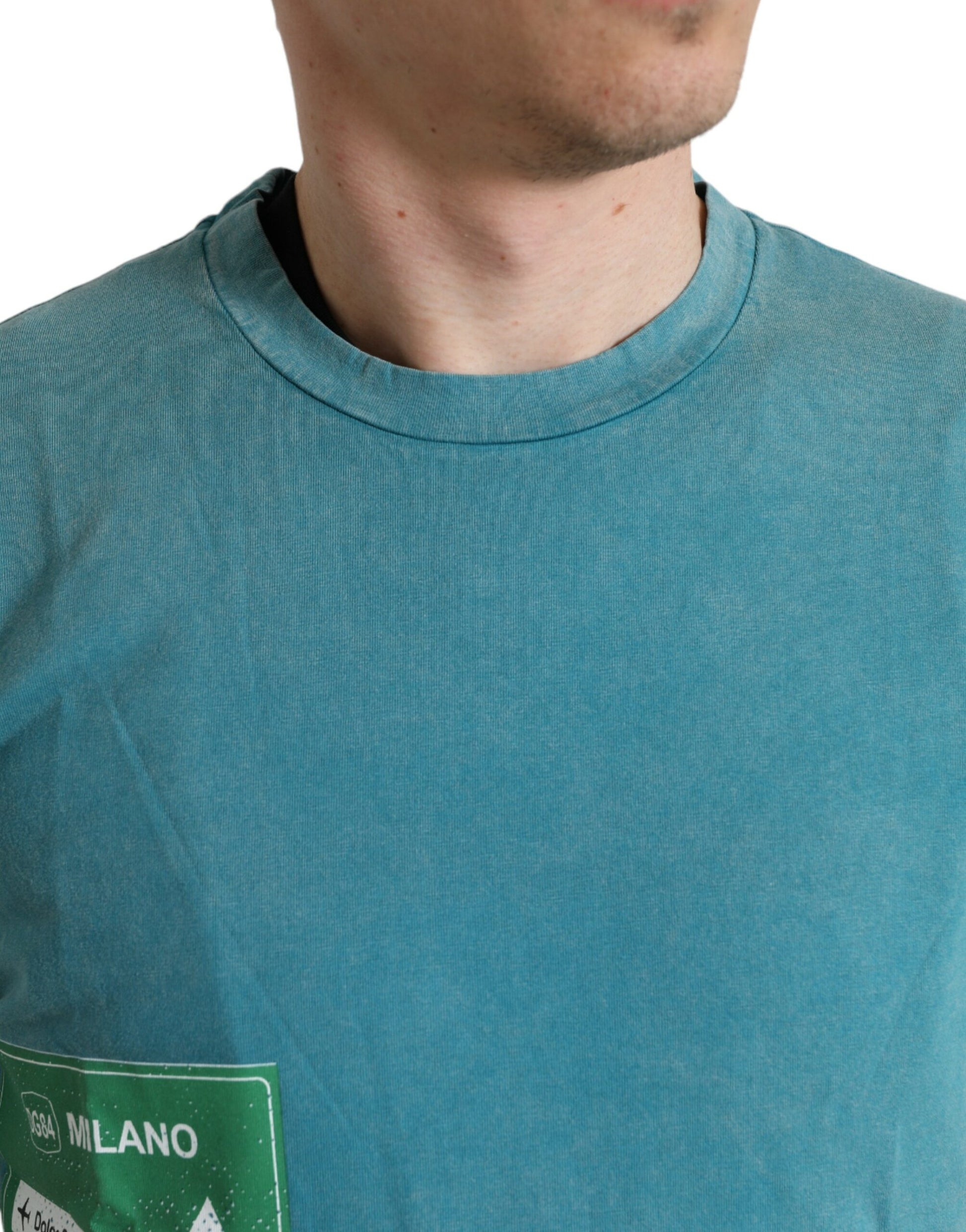 Man wearing blue t-shirt with white logo on chest