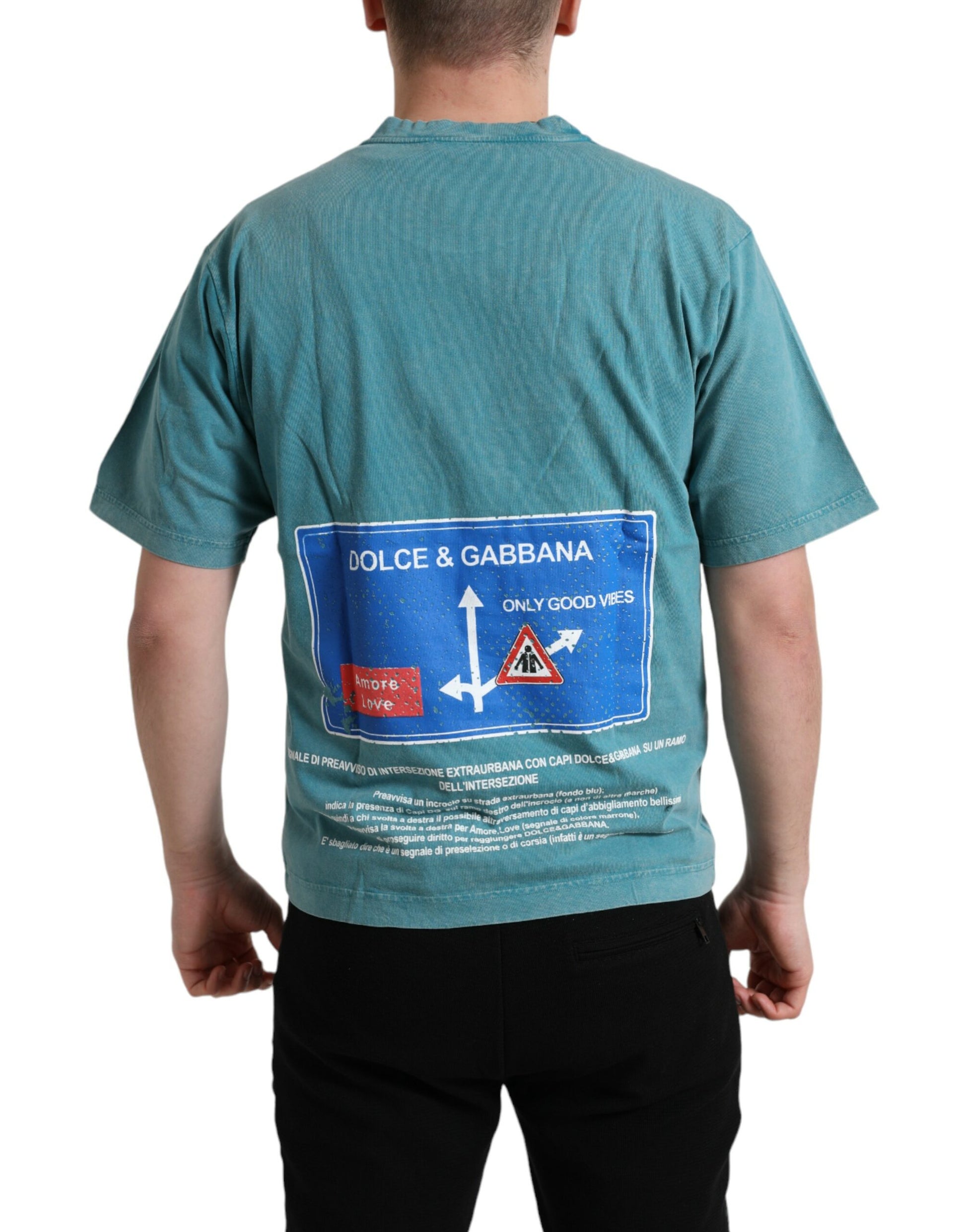 Man wearing a green t-shirt with a sign on his back
