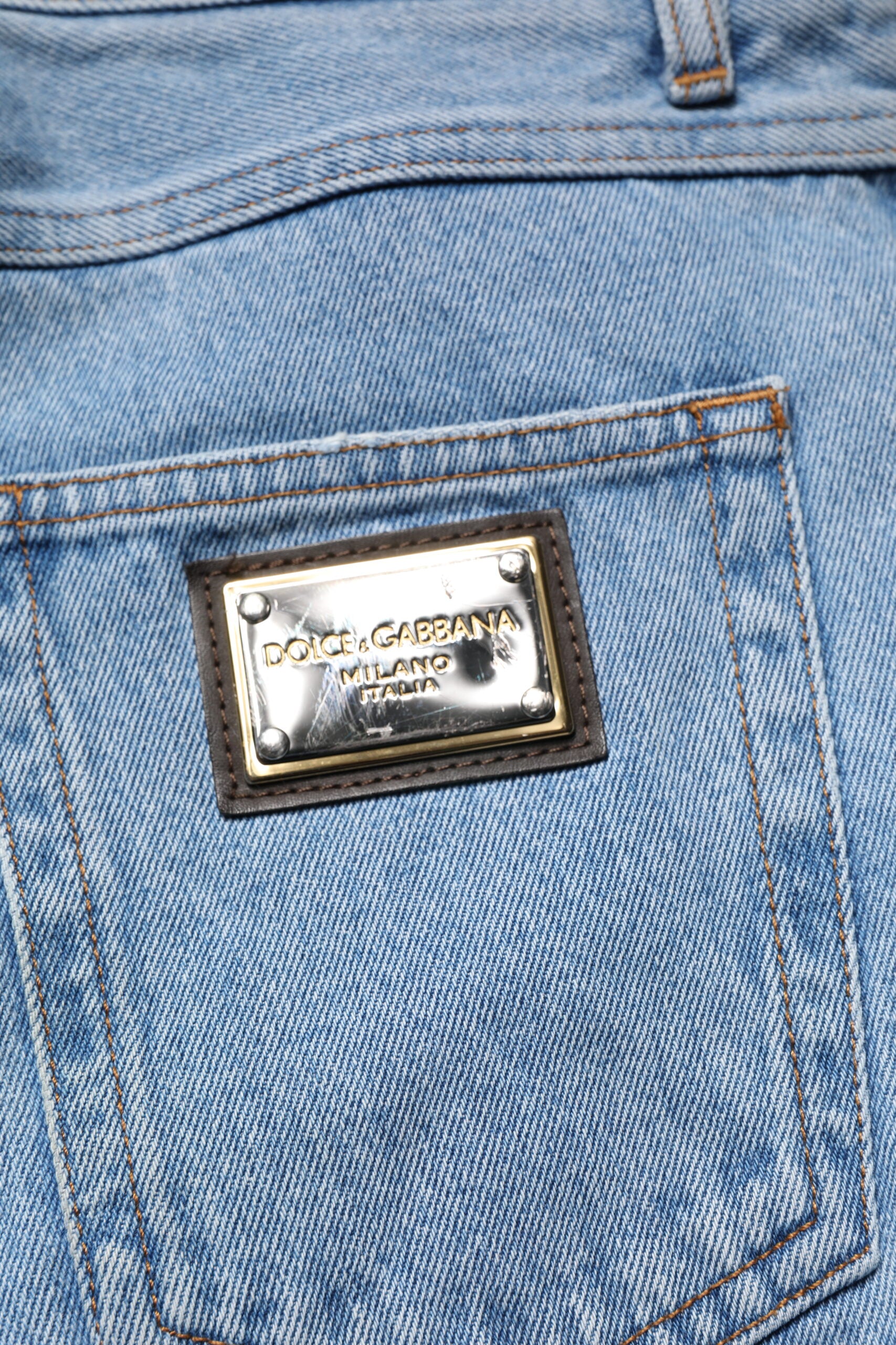 Blue denim jeans with a brand logo on the back pocket