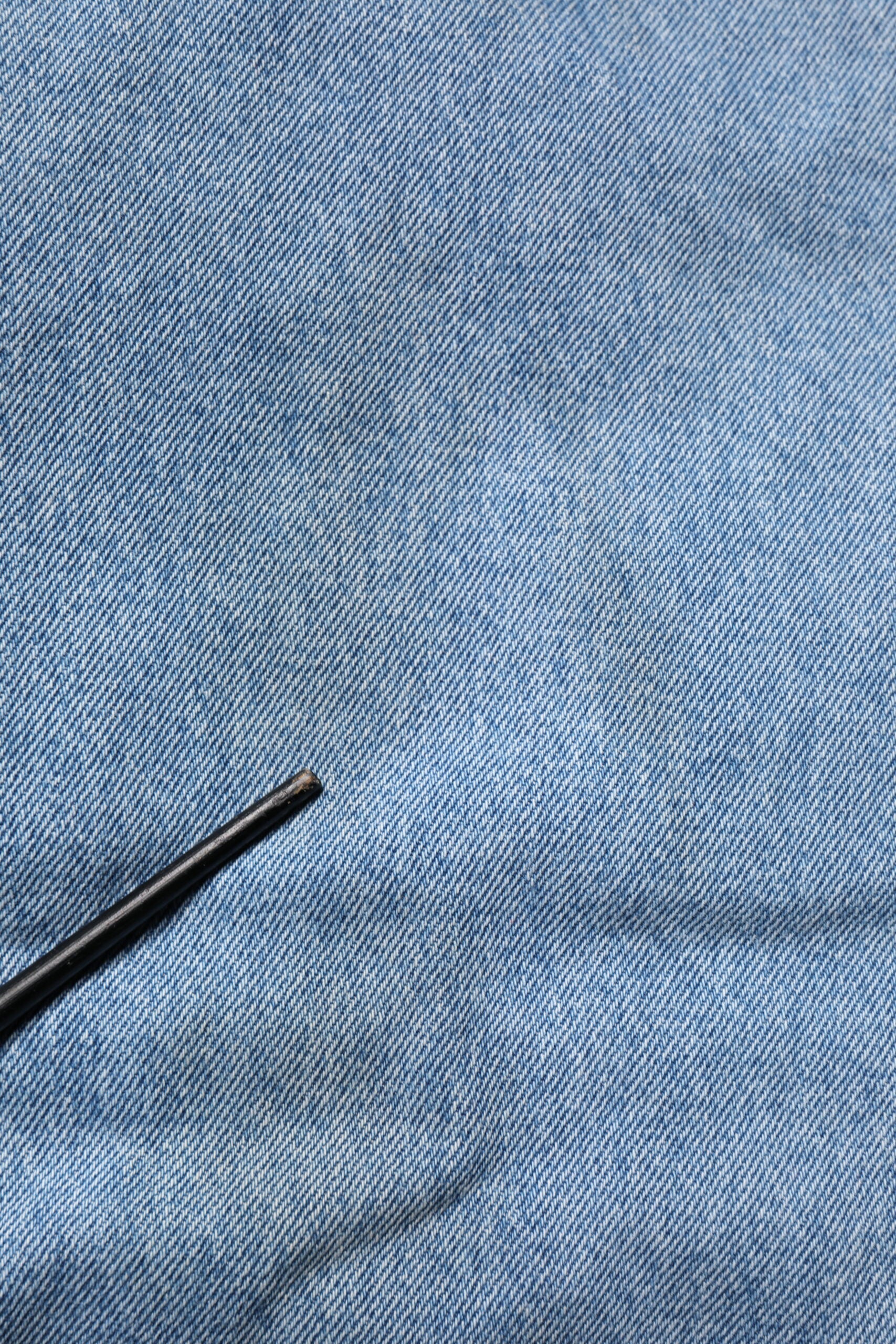 Blue denim jeans with a black pen mark on them