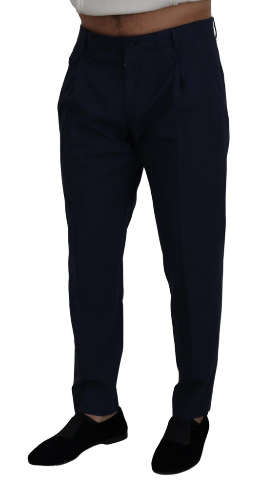Man wearing dark blue trousers and black shoes