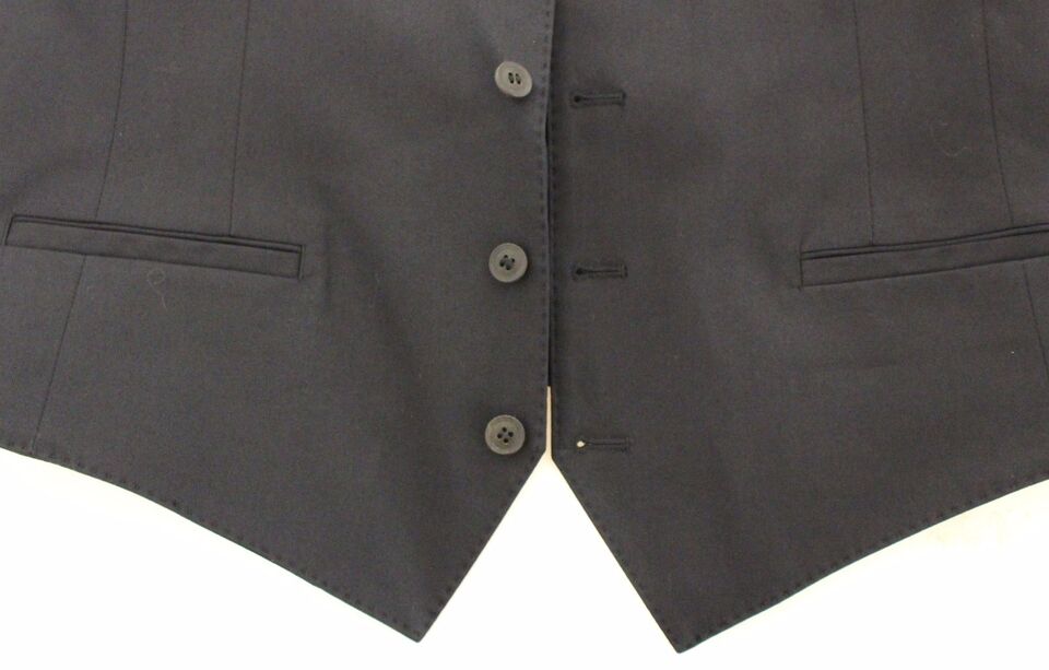 A black blazer with two pockets and buttons on the front