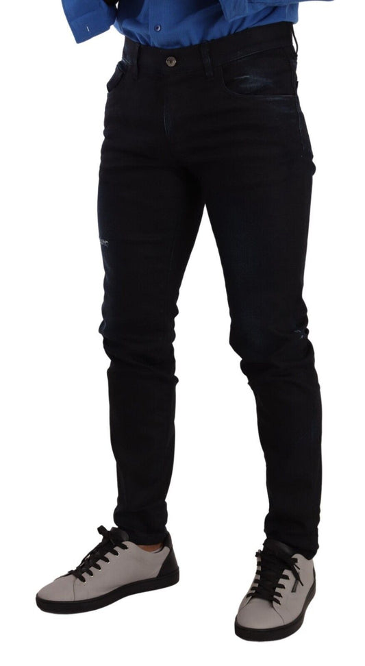 Pair of black jeans on a person standing against white background