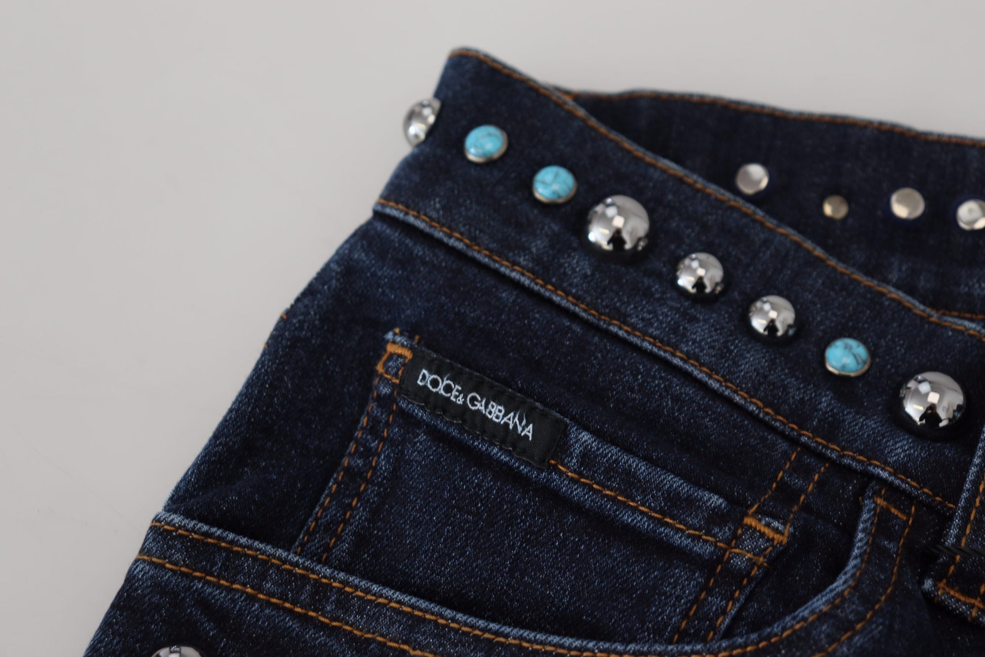 Blue denim jeans with silver studs on waistband