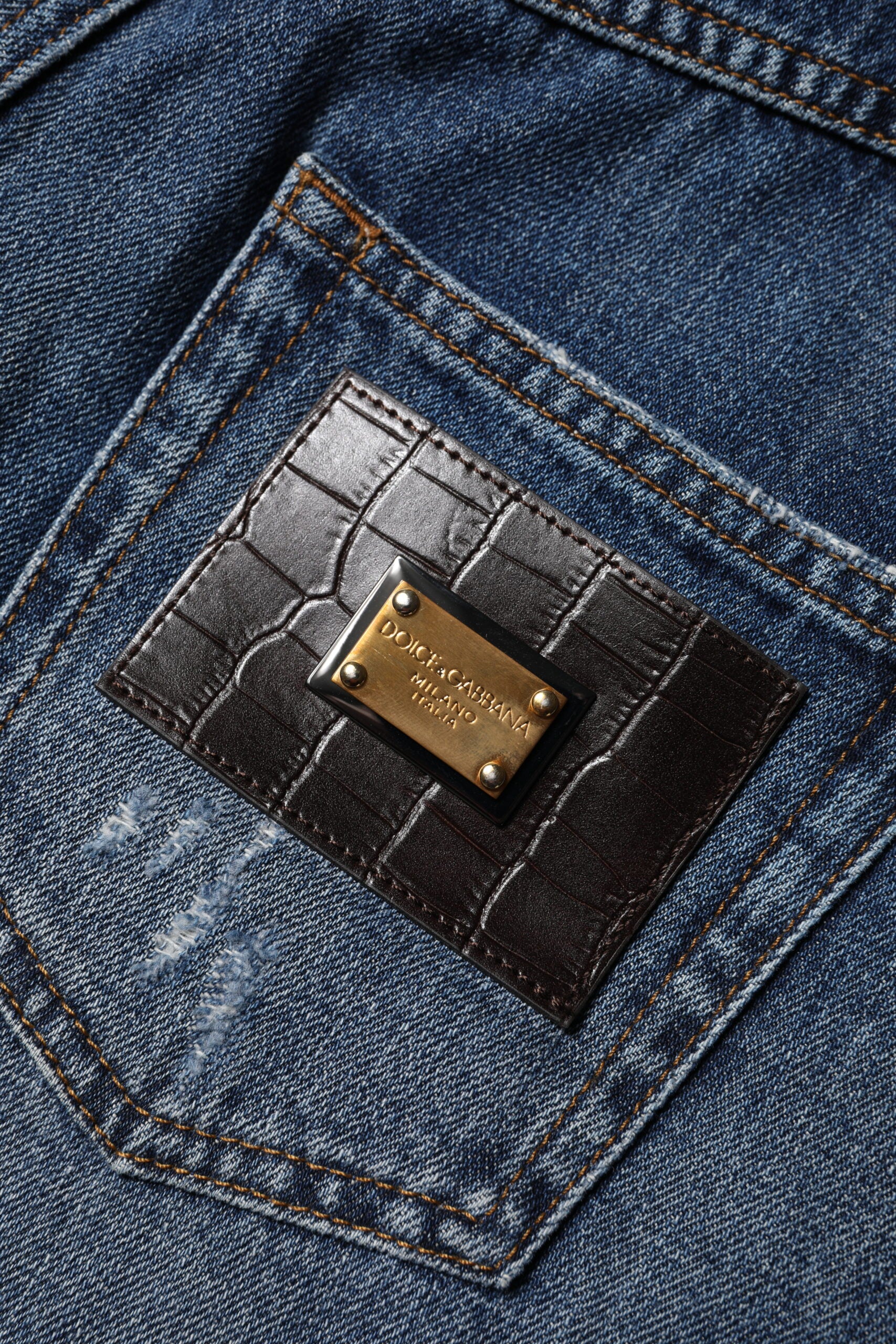 Brown leather branded pocket on blue jeans