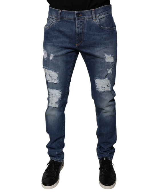 Pair of blue denim jeans with distressed areas on legs