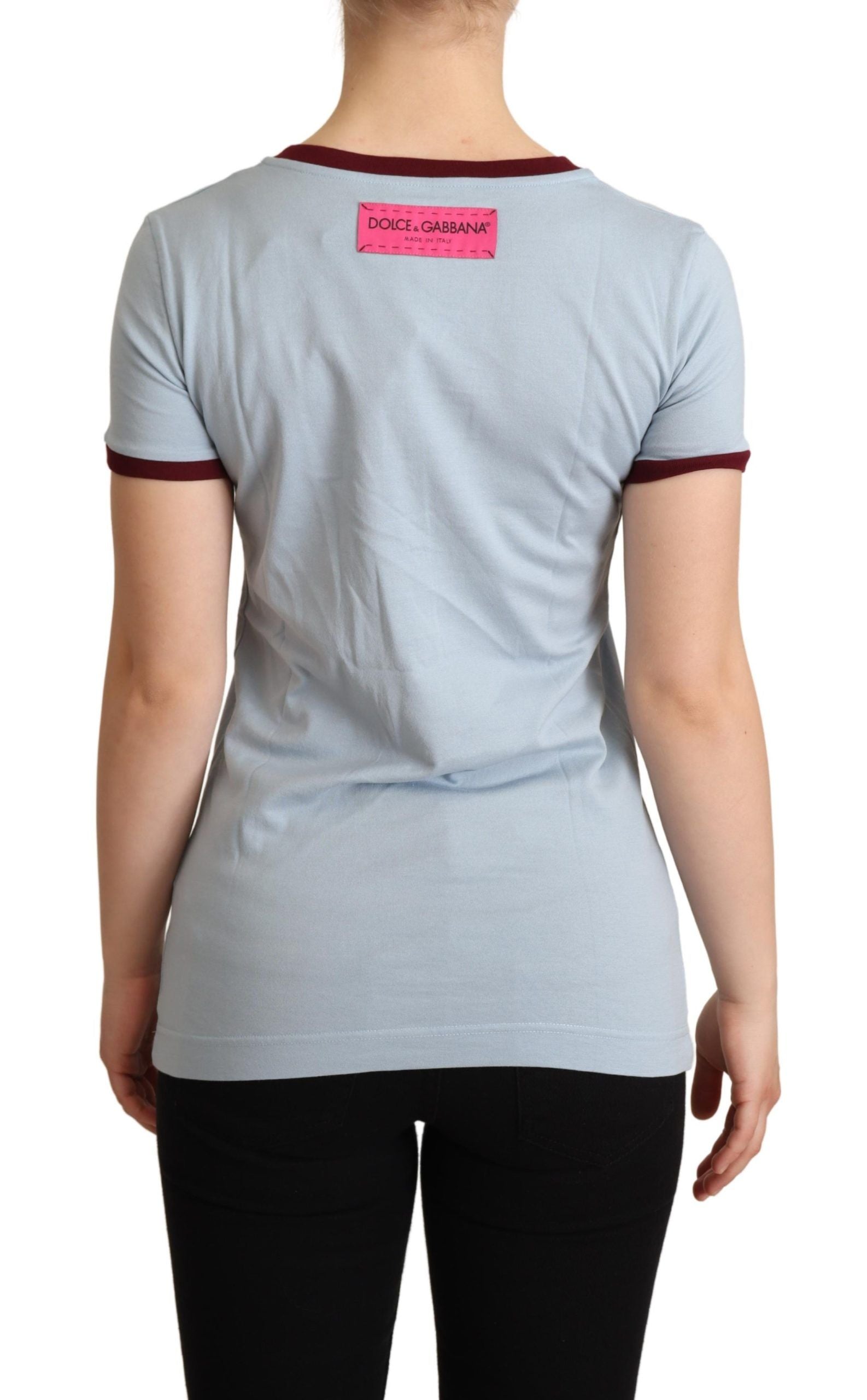 Woman's back wearing a short sleeve shirt with pink label on back