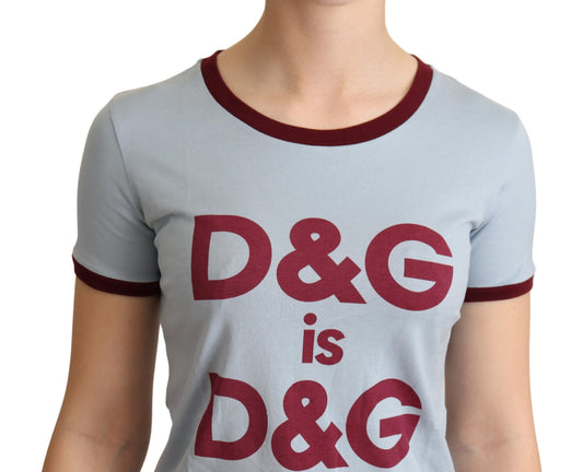 Woman wearing gray shirt with red letters spelling D&G