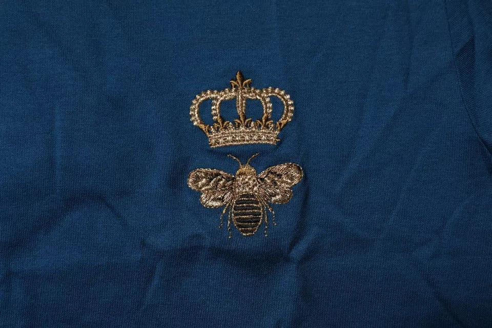 Gold bee embroidery on blue fabric