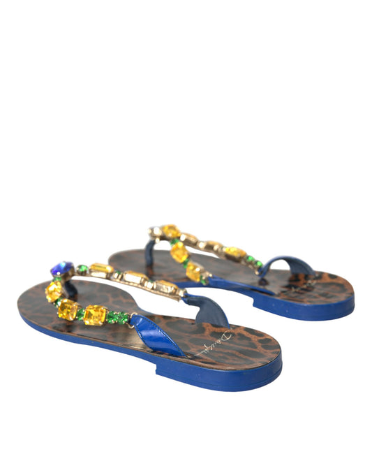 Pair of blue flip flops with gold accents and jewels