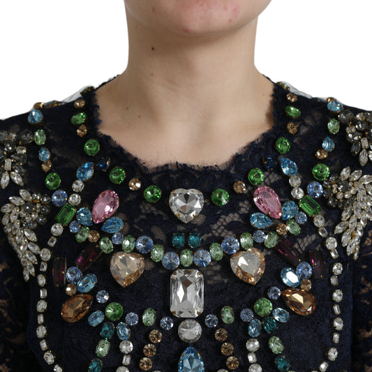 A woman wearing a blue crystal floral lace long gown dress with intricate beading and embroidery