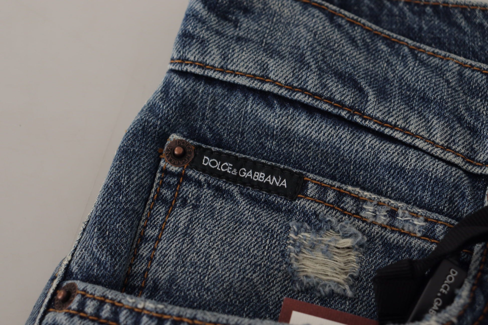 Blue denim jeans with brand label on front pocket