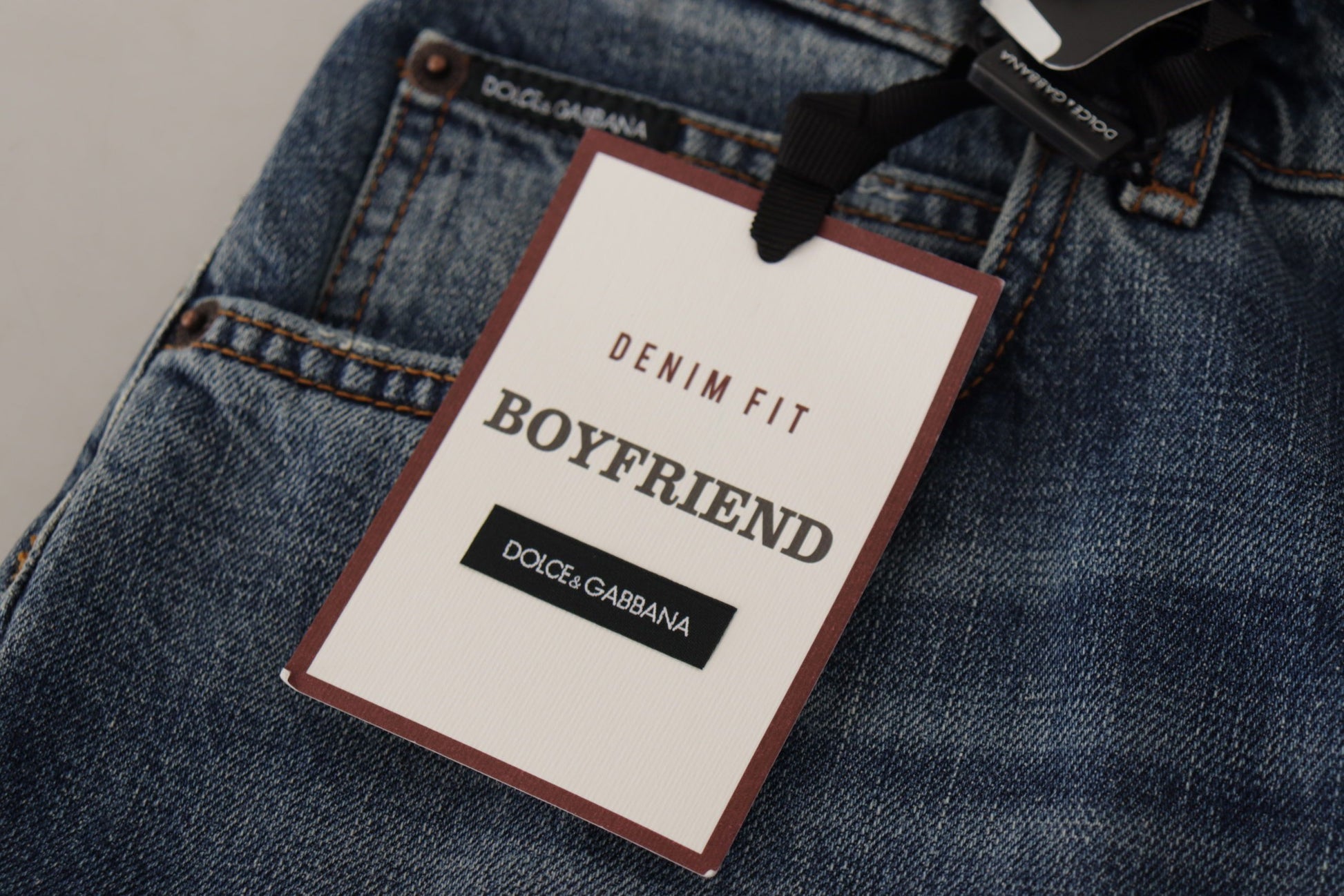 Blue denim jeans with tag attached to waistband