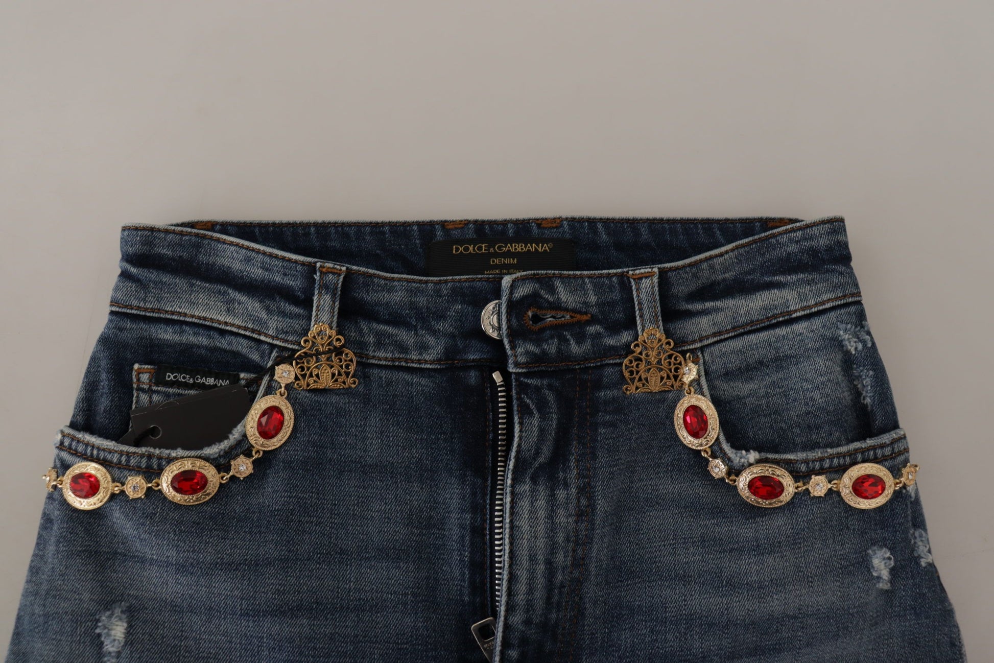 Blue denim jeans with red embellishments on side pockets