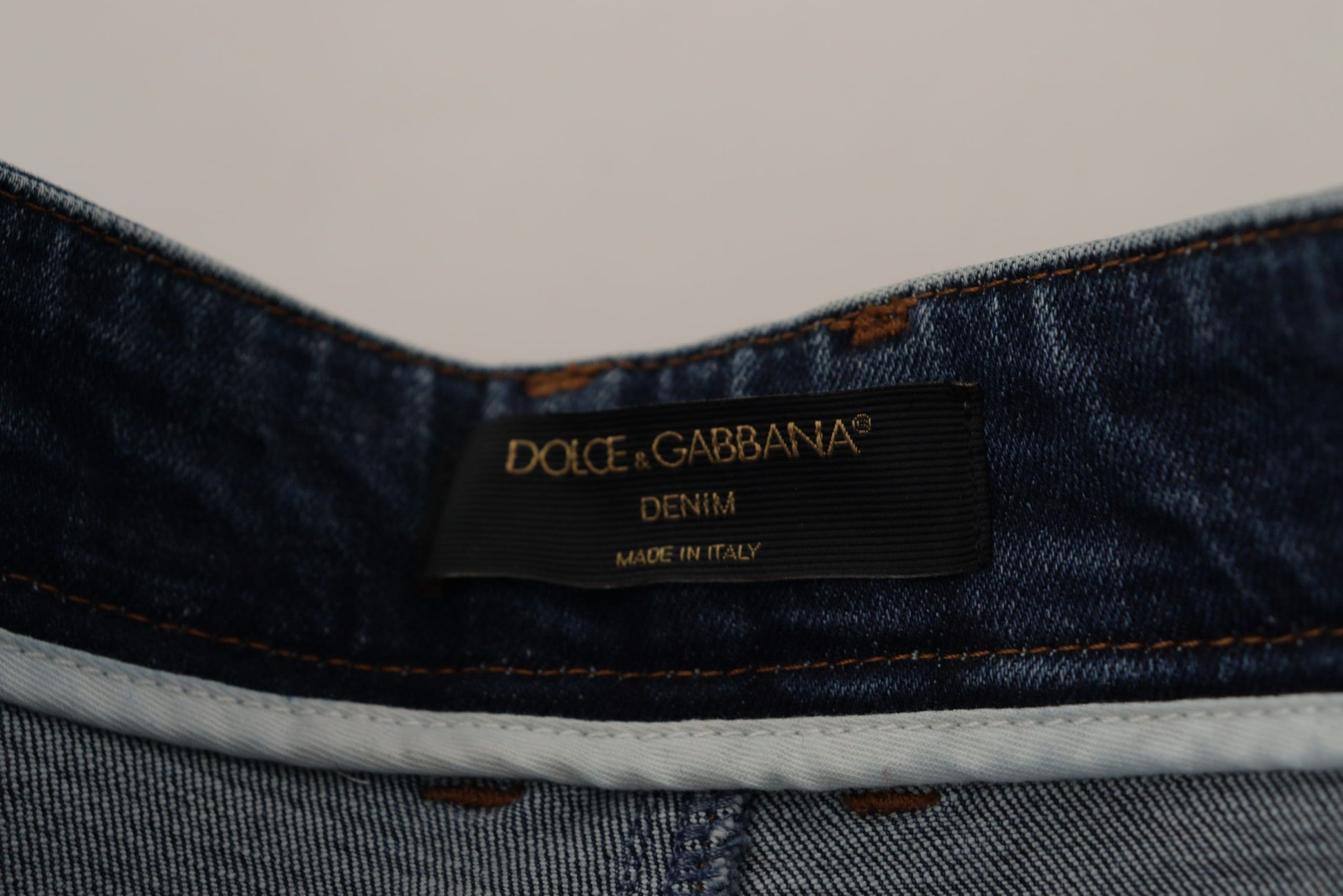 Blue denim jeans with brand label on waistband