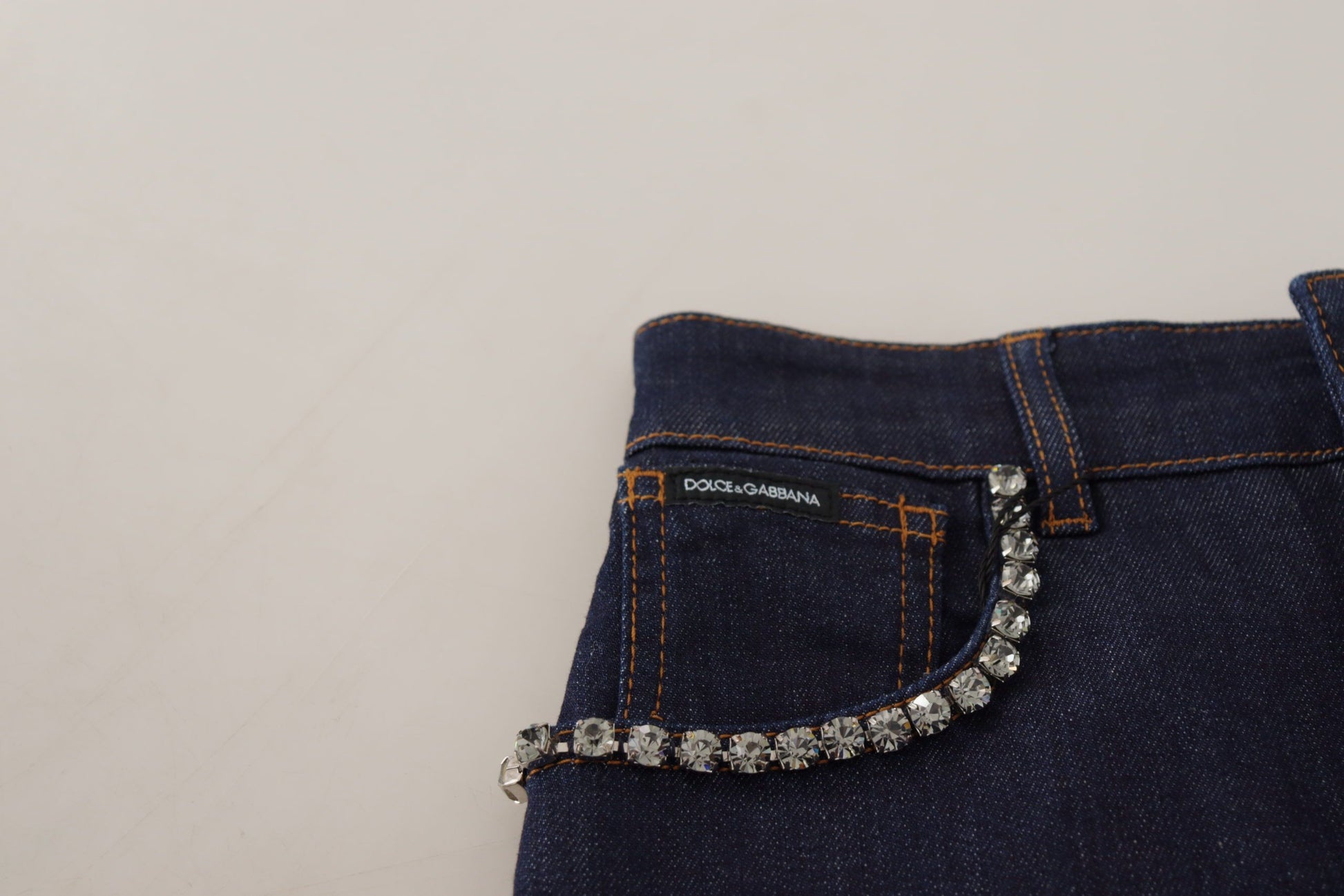 Blue denim jeans with a silver sequin belt loop