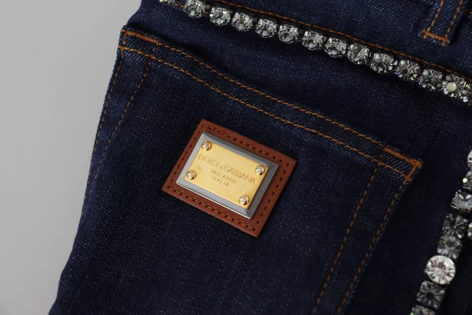 A pair of blue denim stretch crystal hot pants shorts with a gold label on the waistband
