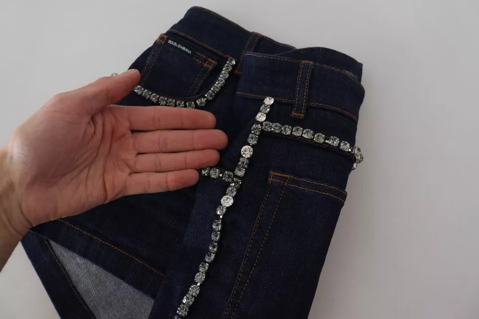 A pair of blue denim stretch crystal hot pants shorts with a cross stitched on the side