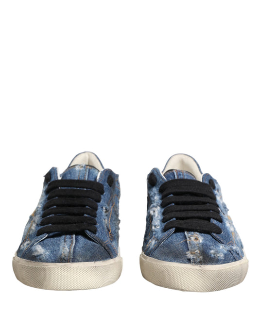 Pair of blue denim sneakers with distressed design and white soles