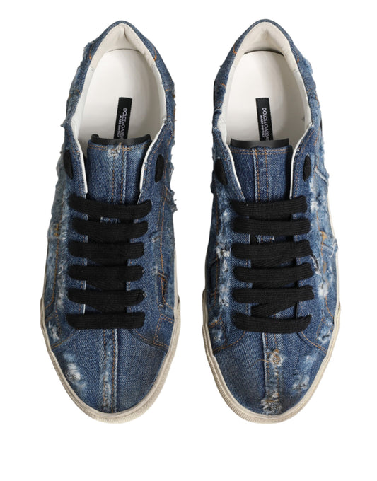 Pair of blue denim sneakers with distressed design and black laces