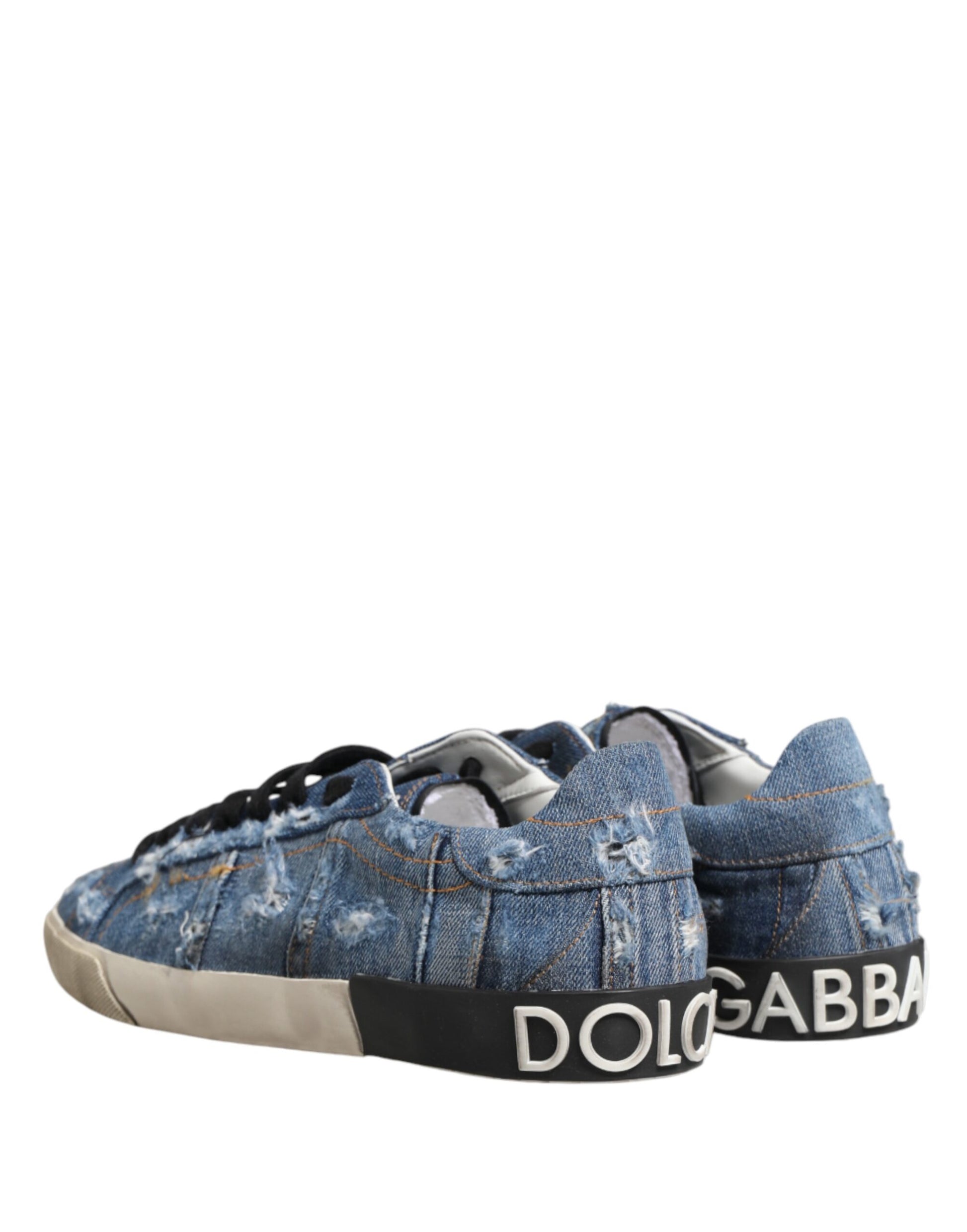 A pair of blue distressed denim sneakers with white soles, featuring the Dolce & Gabbana logo