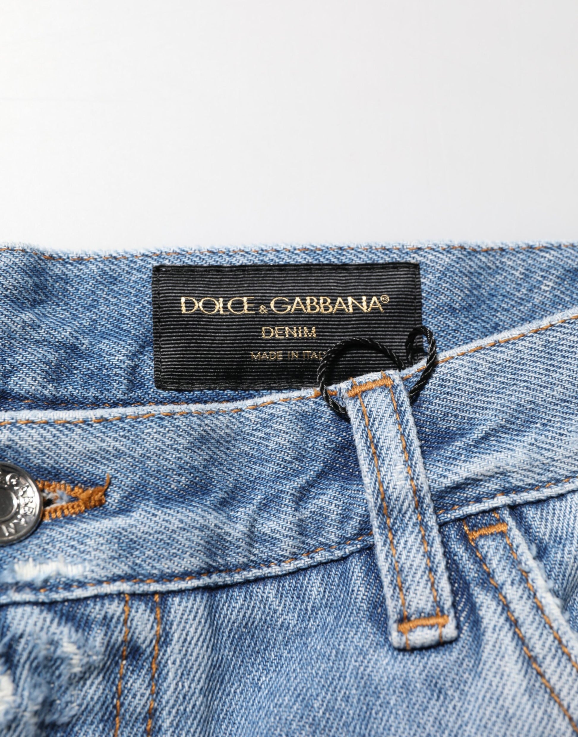 Blue denim jeans with a black label on the waistband
