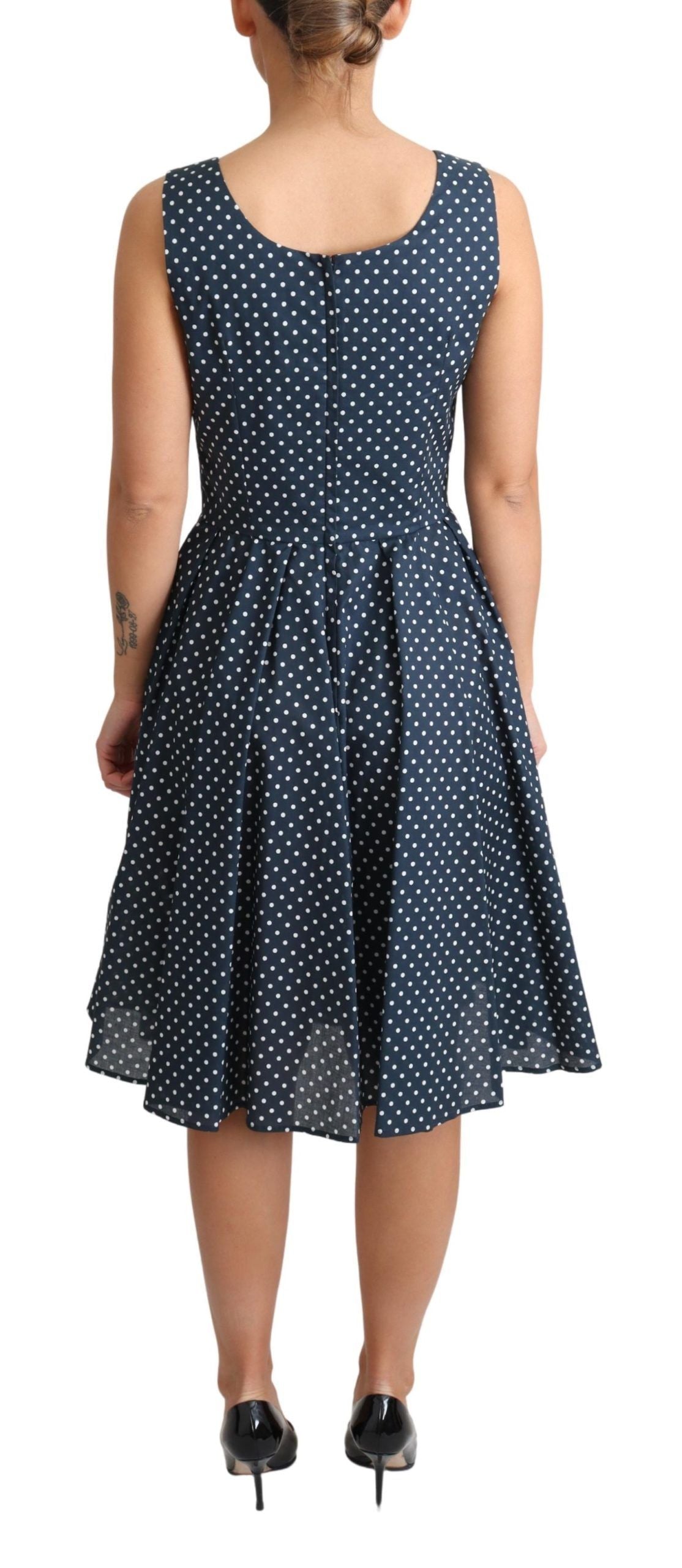 A blue dress with white polka dots, featuring an A-line silhouette. It is made of cotton and has short sleeve
