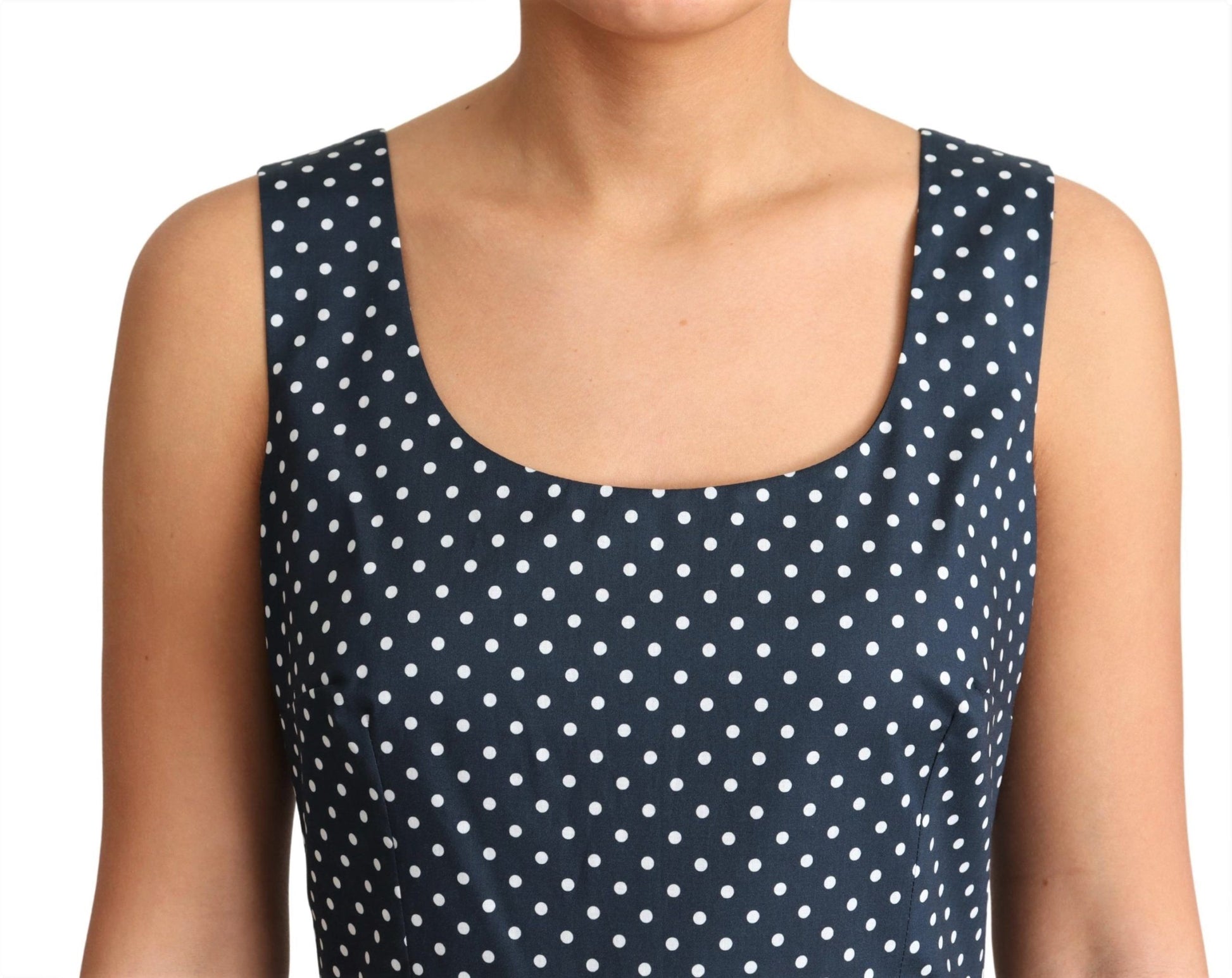 A blue dress with white polka dots, featuring an A-line silhouette. It is made of cotton and has short sleeve