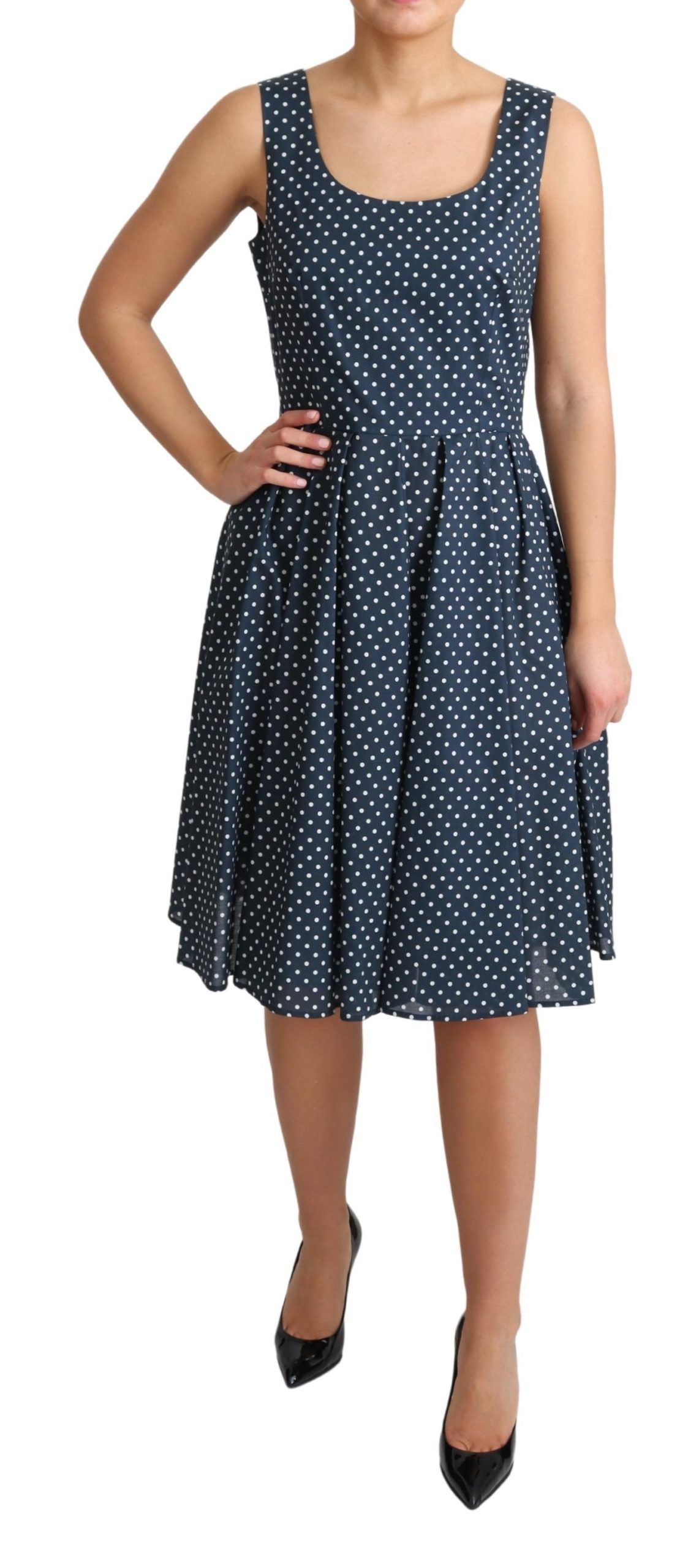 A blue dress with white polka dots, featuring an A-line silhouette. It is made of cotton and has short sleeve