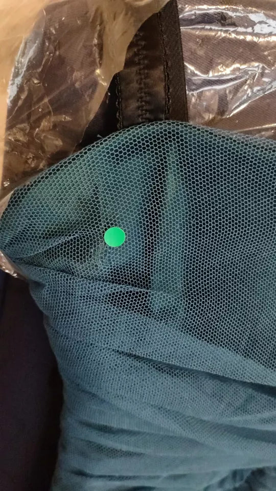 A green dot on a blue dress
