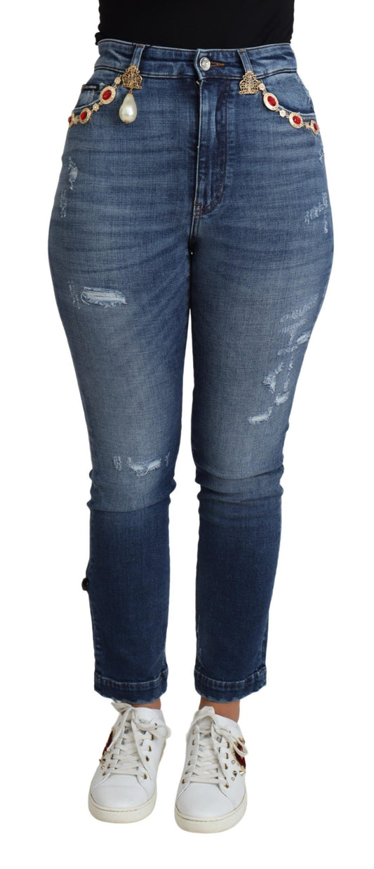 Blue denim jeans with rips and studs on waistband