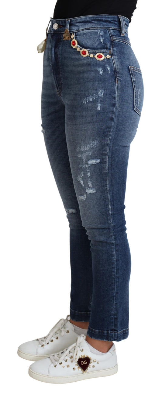 Woman wearing blue denim jeans with distressed areas and a white sneaker with gold accents