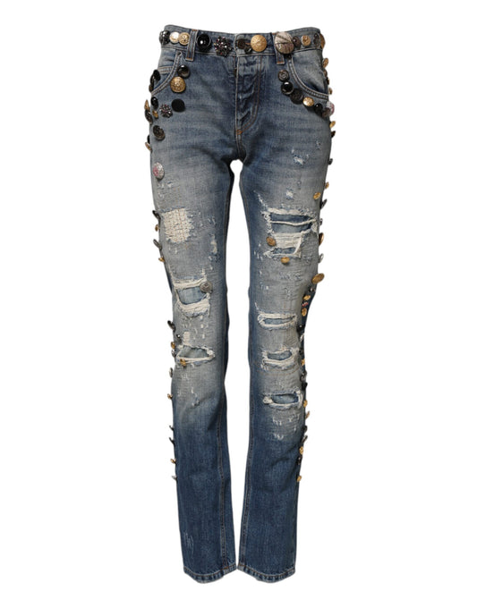 Pair of distressed denim jeans with rips and studs on legs