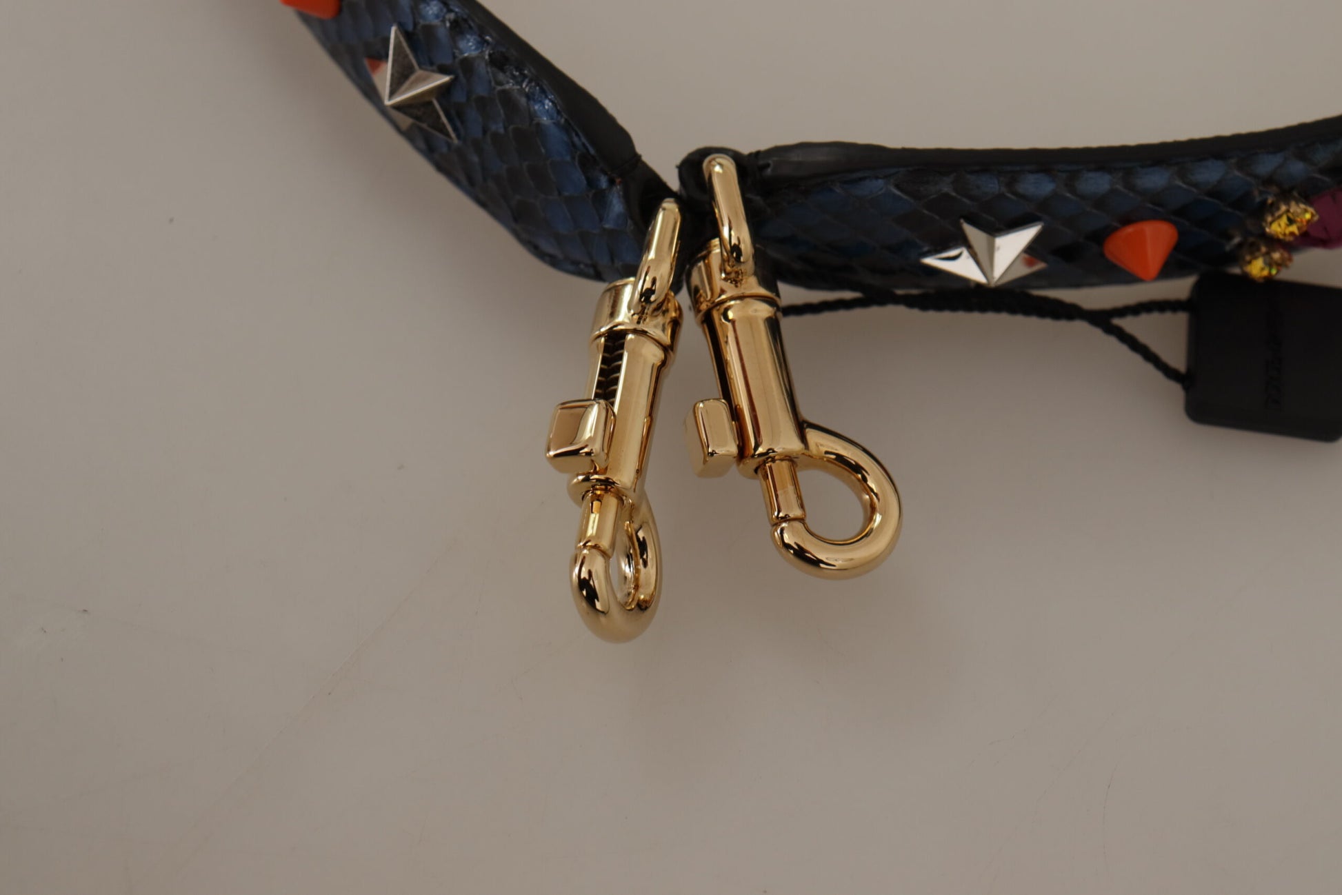 Gold key chain on blue leather dog collar