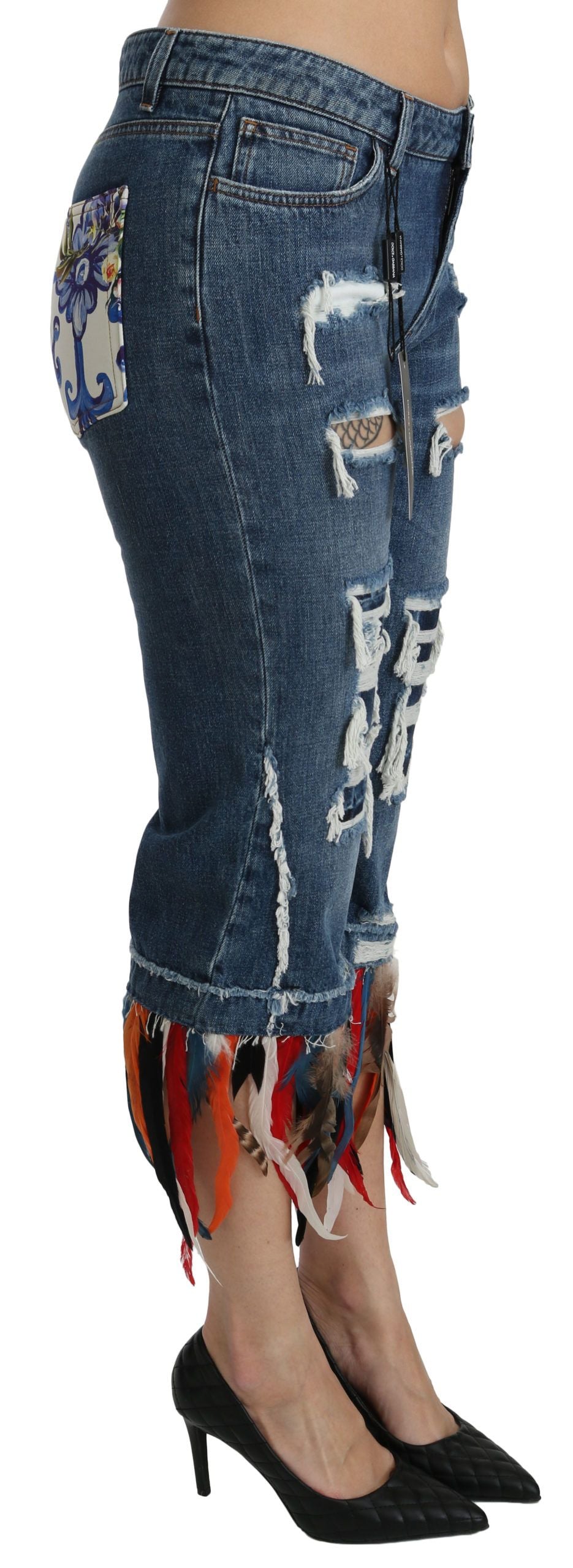 Woman wearing distressed denim jeans with fringe details on legs