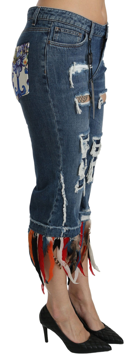 Woman wearing distressed denim jeans with fringe details on legs