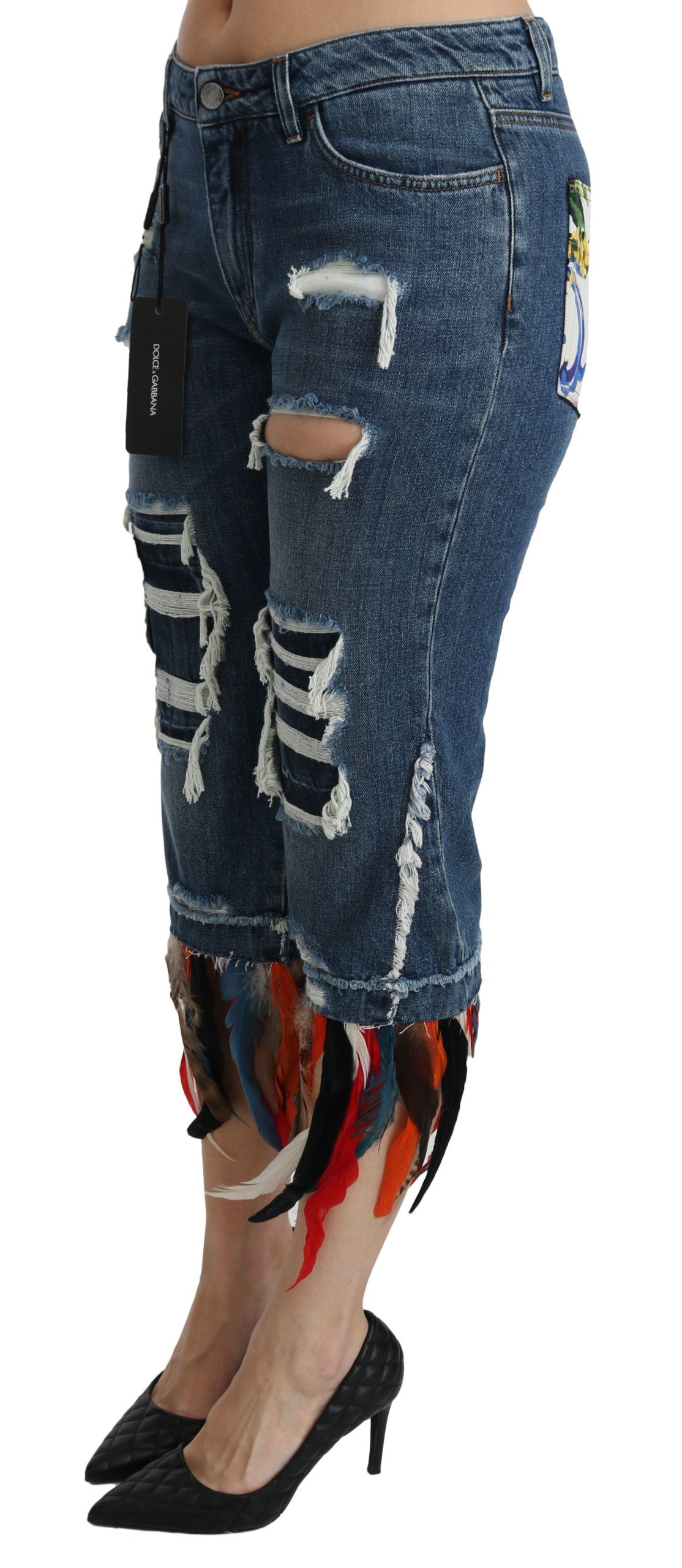 Woman wearing distressed denim jeans with fringe details on legs