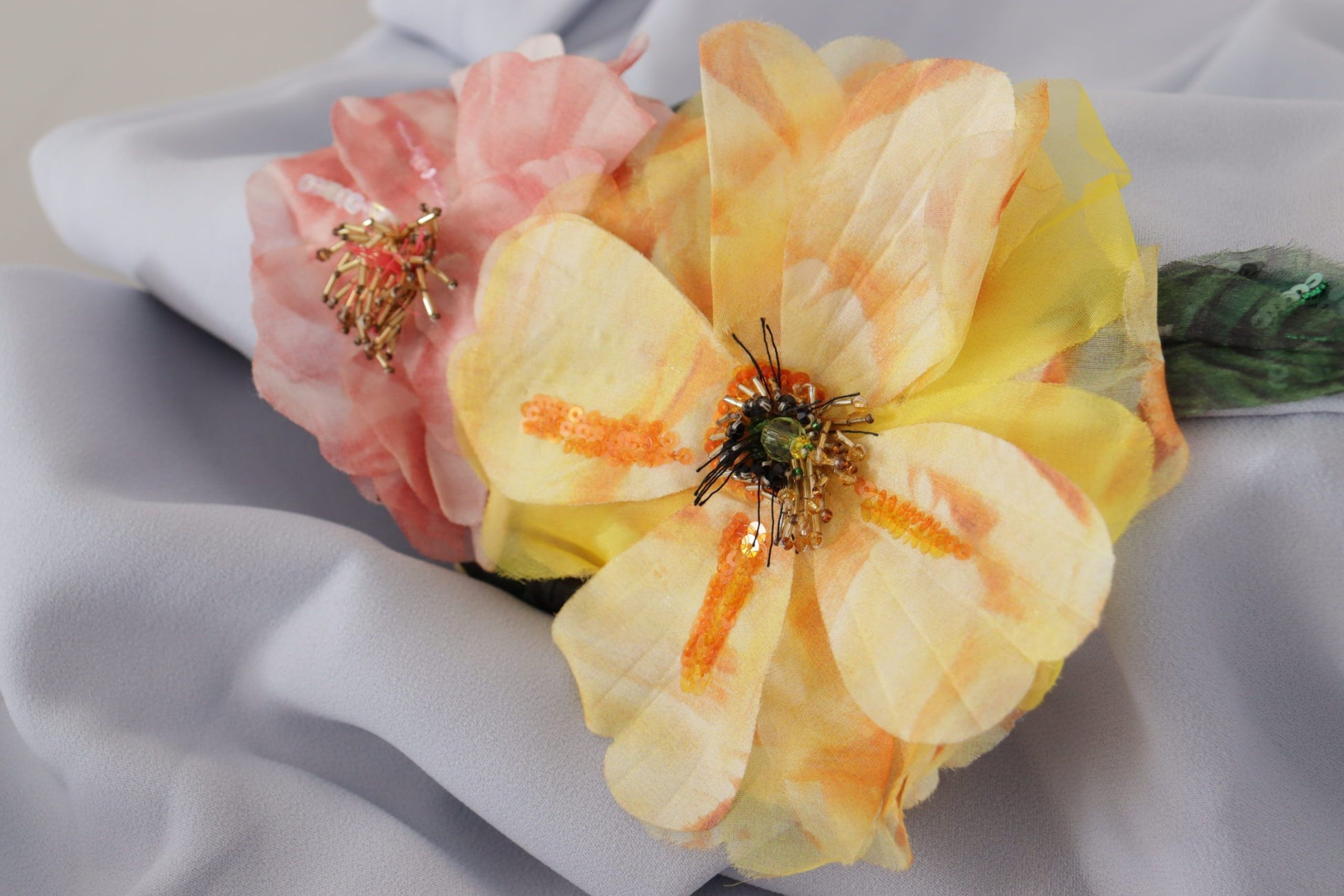 A floral applique midi dress with a blue background and yellow, pink, and white flowers