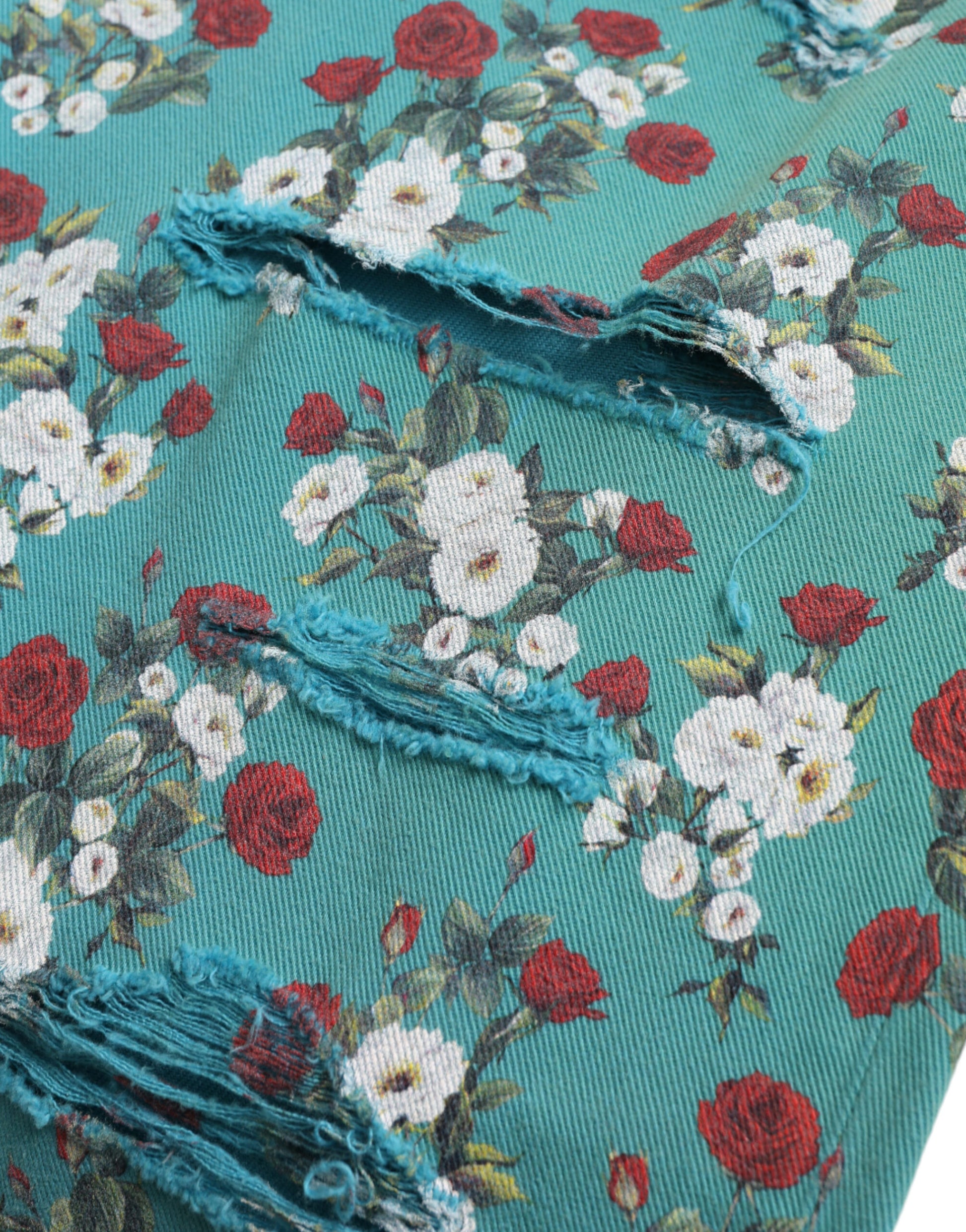 Blue fabric with floral pattern, torn at seam