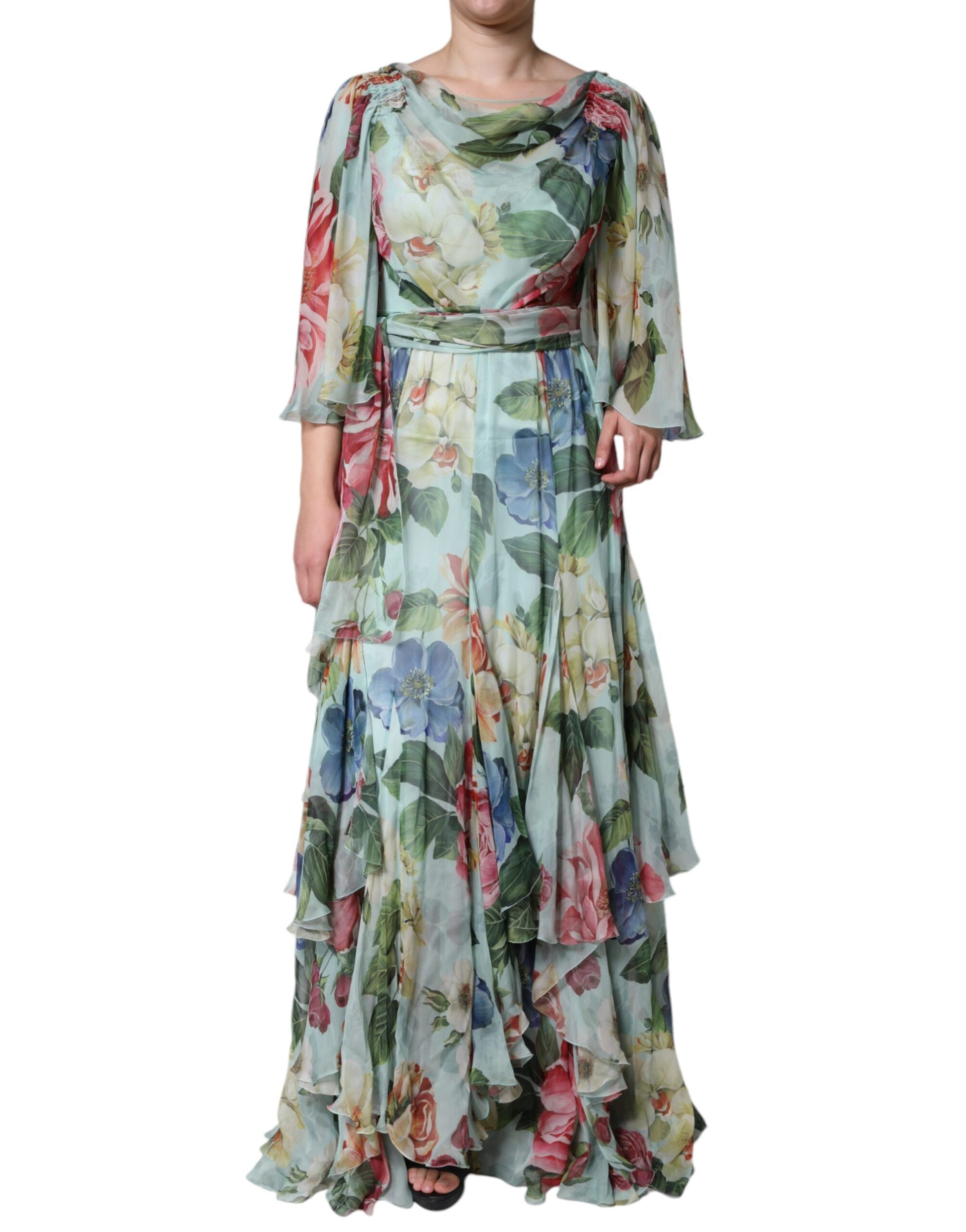 A long blue floral print dress with tiered ruffles and a belted waist