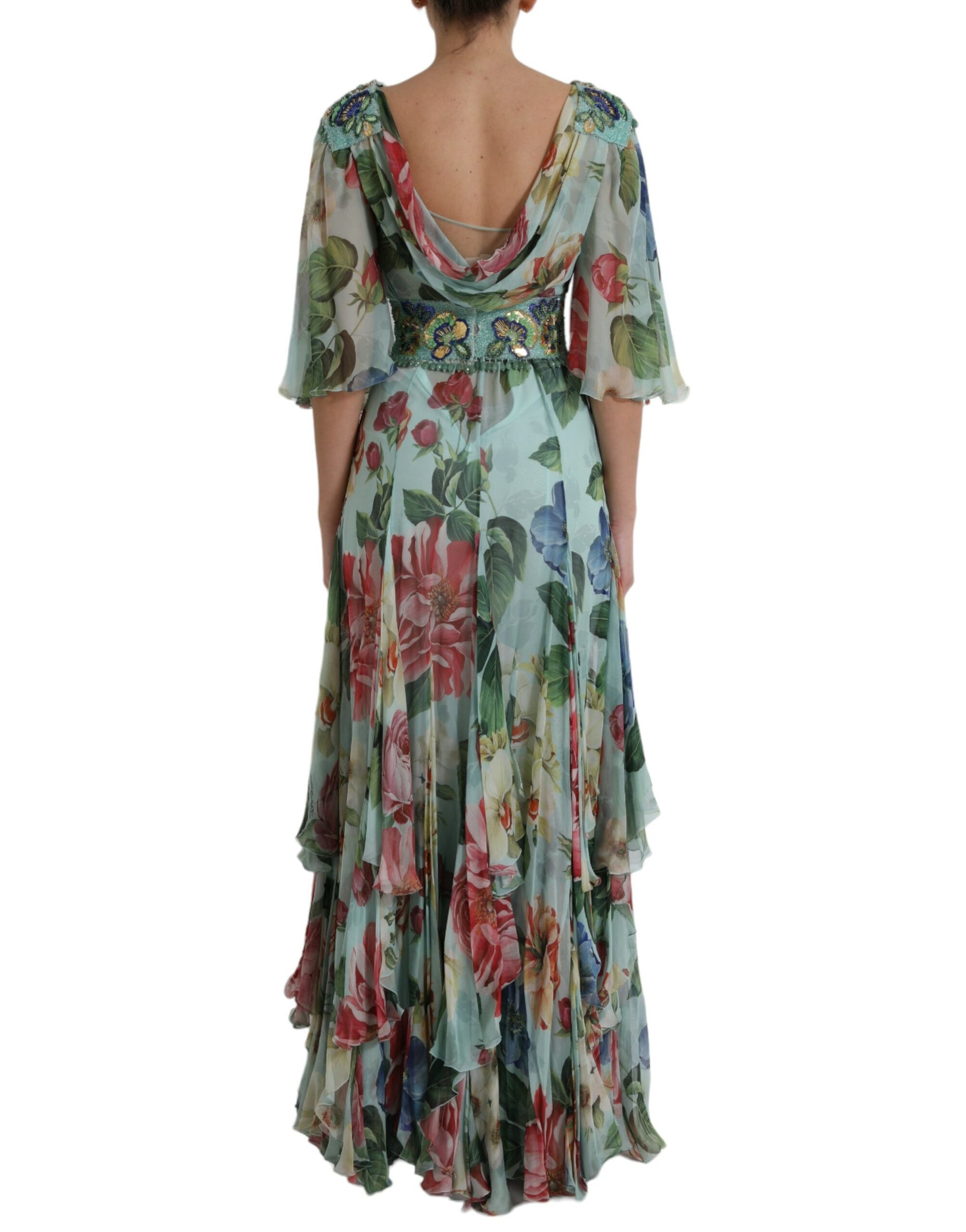 A long blue floral print dress with tiered skirt and sleeveless design